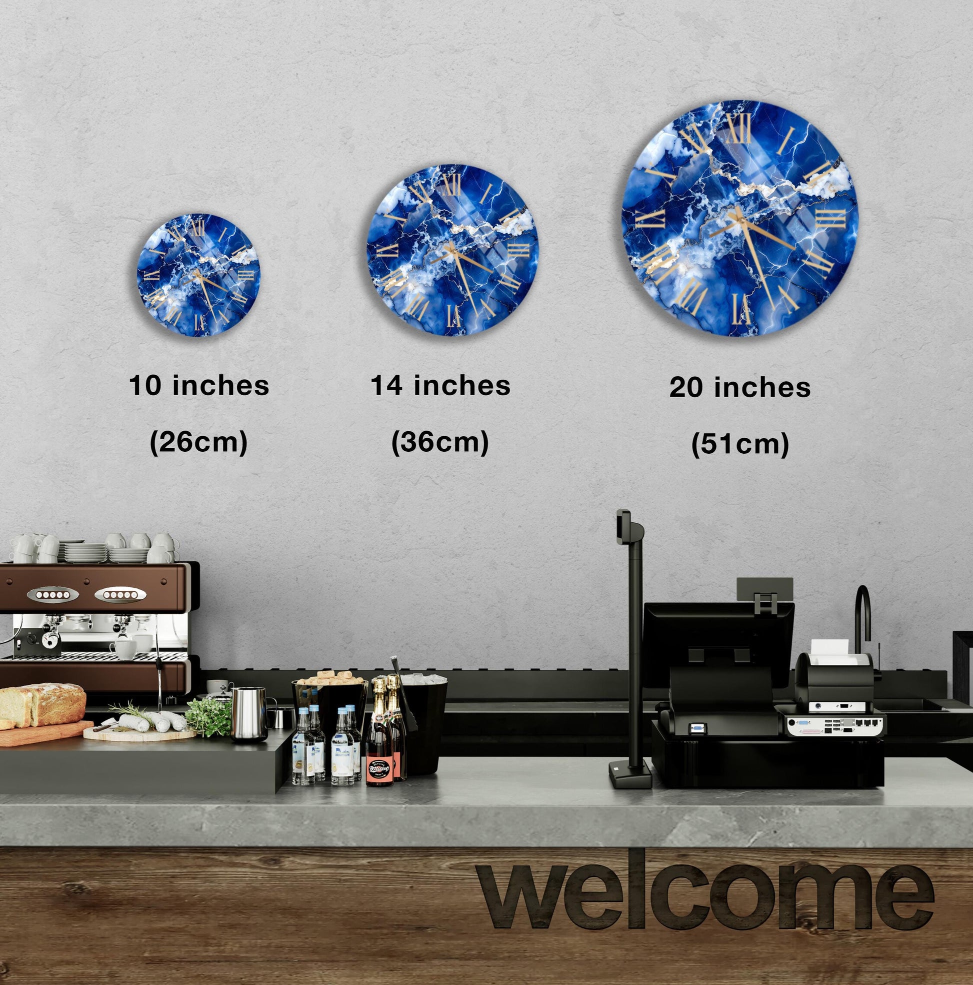 a wall with three clock designs, each representing a different size: 10 inches, 14 inches, and 20 inches. Below the clocks, there is a counter with various items such as bottles and a cash register. The word "welcome" is also visible in the image.