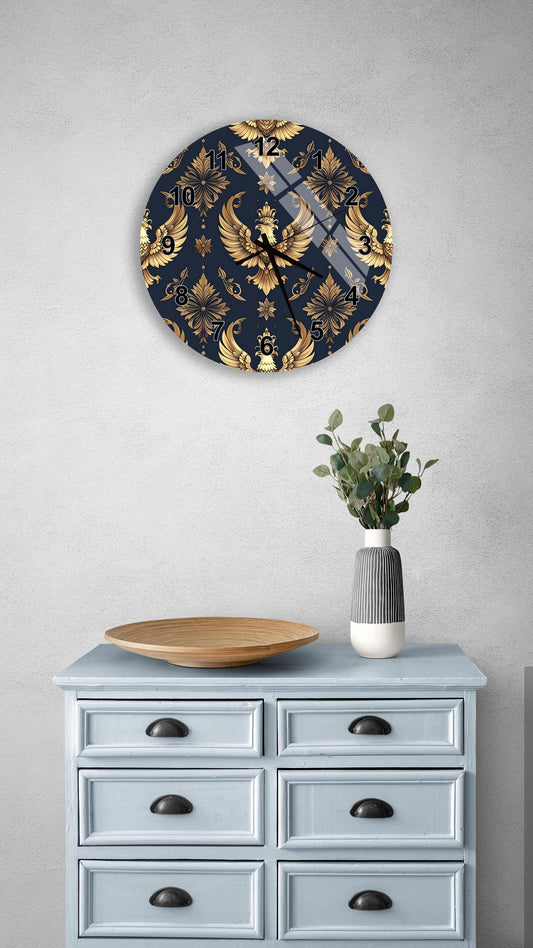 a wall clock with a gold and black damask pattern, mounted on a wall above a light blue dresser with six drawers. The dresser also has a vase with greenery and a wooden bowl on it.