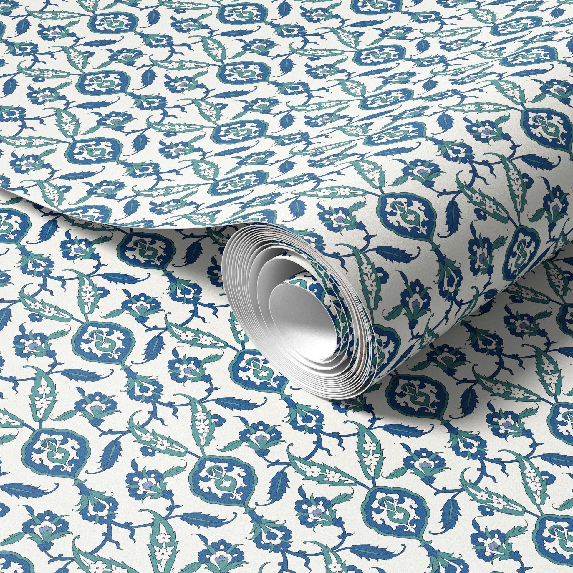 a roll of wallpaper with a repeating pattern of blue and white floral designs.