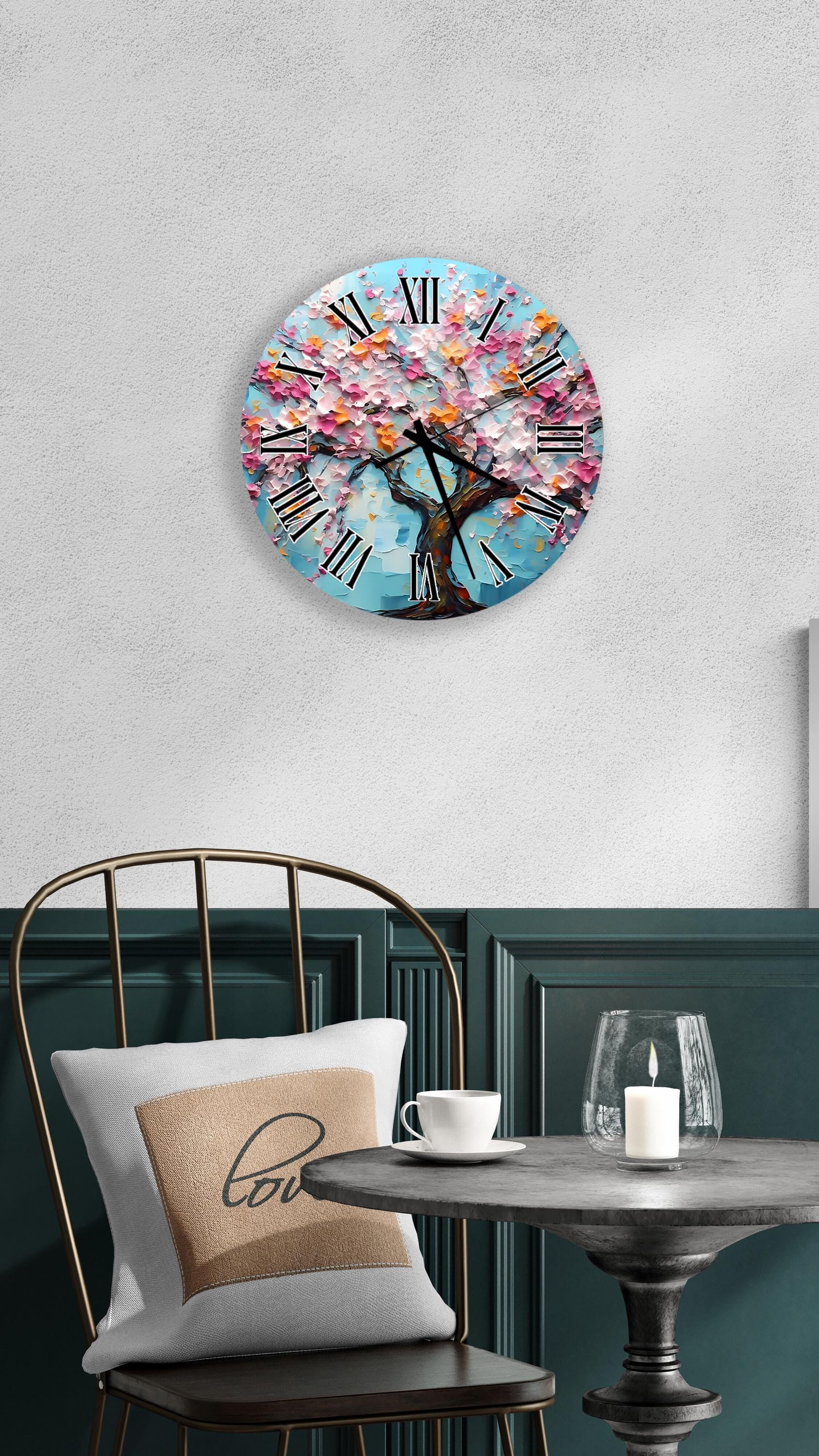 a round wall clock with a tree design, mounted on a wall above a table with a white tablecloth.