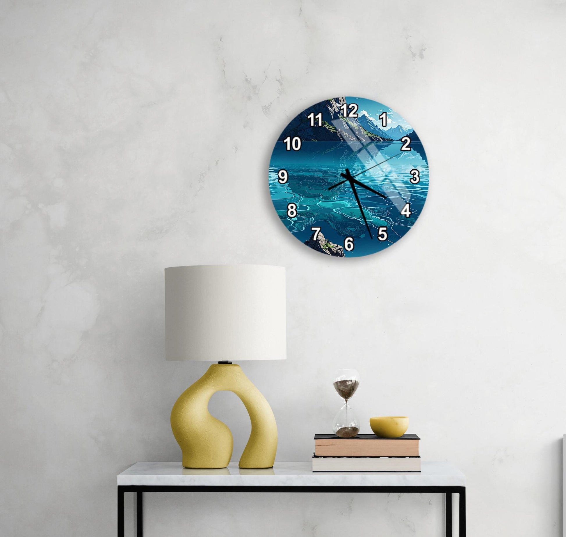 a wall clock with a blue ocean scene, a yellow lamp, a stack of books, and a glass of wine on a white table.