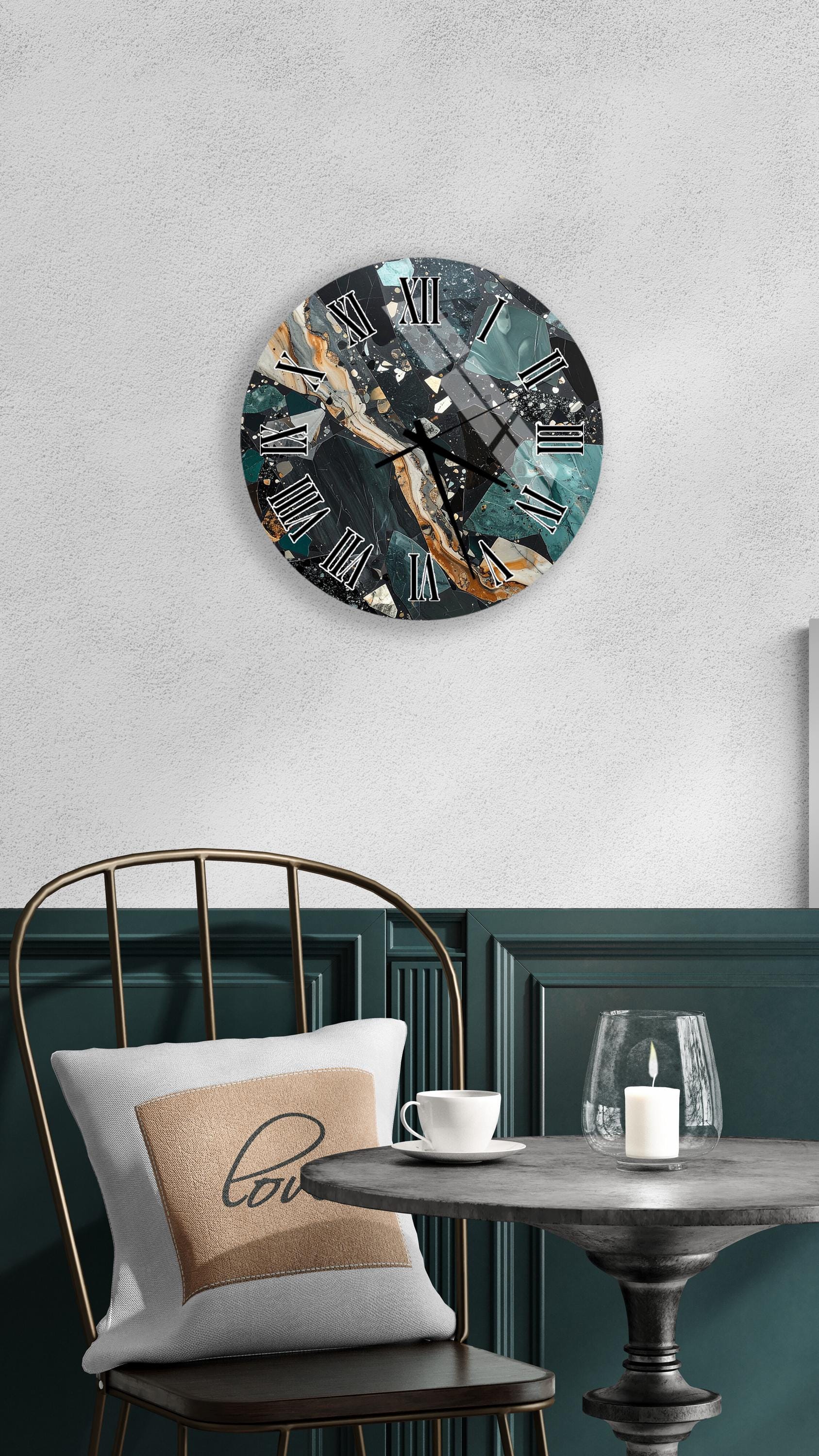 a modern and stylish interior design with a round wall clock featuring a marble-like pattern, a white table with a candle and a cup, and a black metal chair with a white pillow.