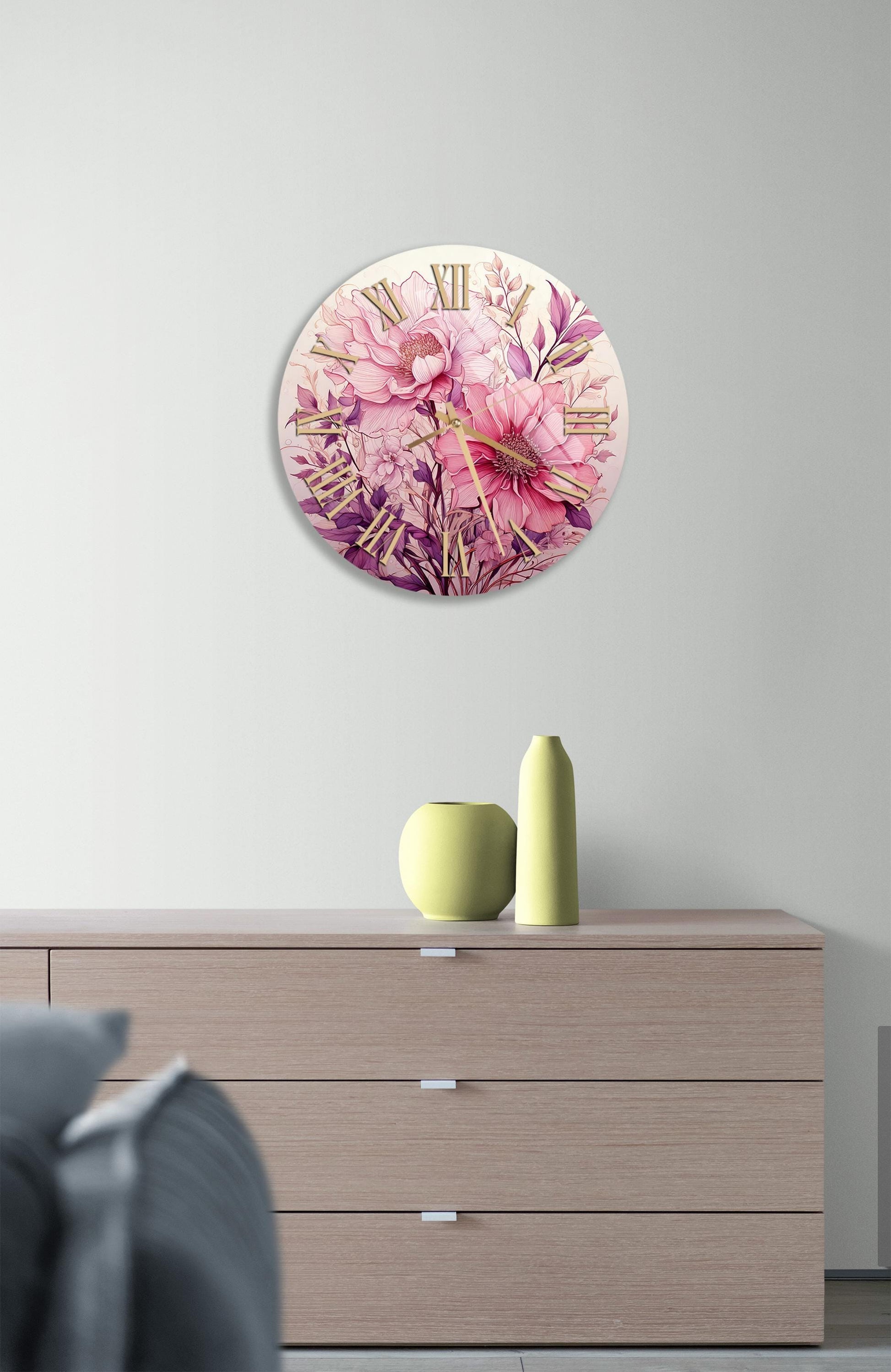 a clock with pink flowers on the face of it