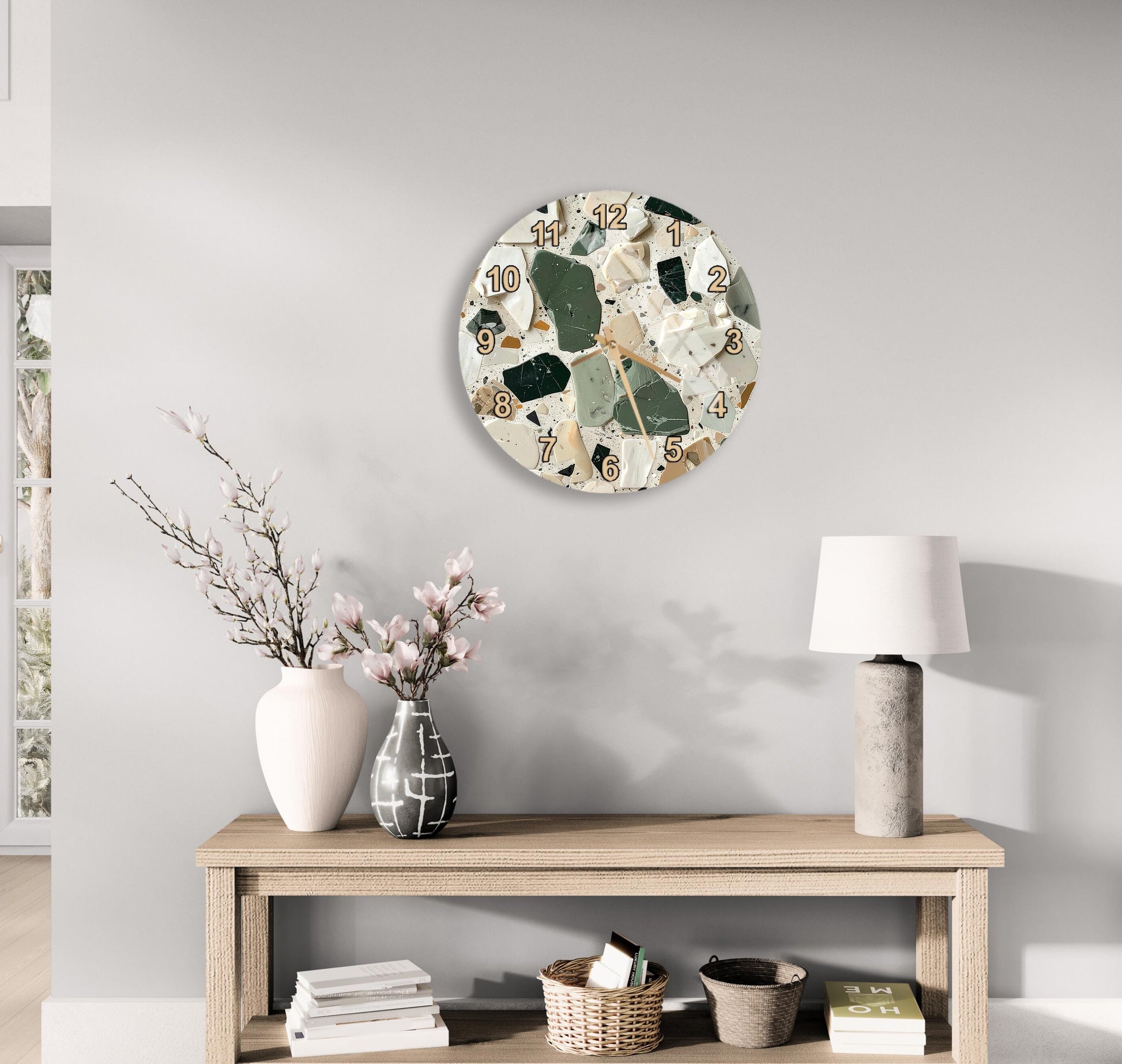 a modern living room with a wooden table, a lamp, a vase with flowers, and a round wall clock with a mosaic design.