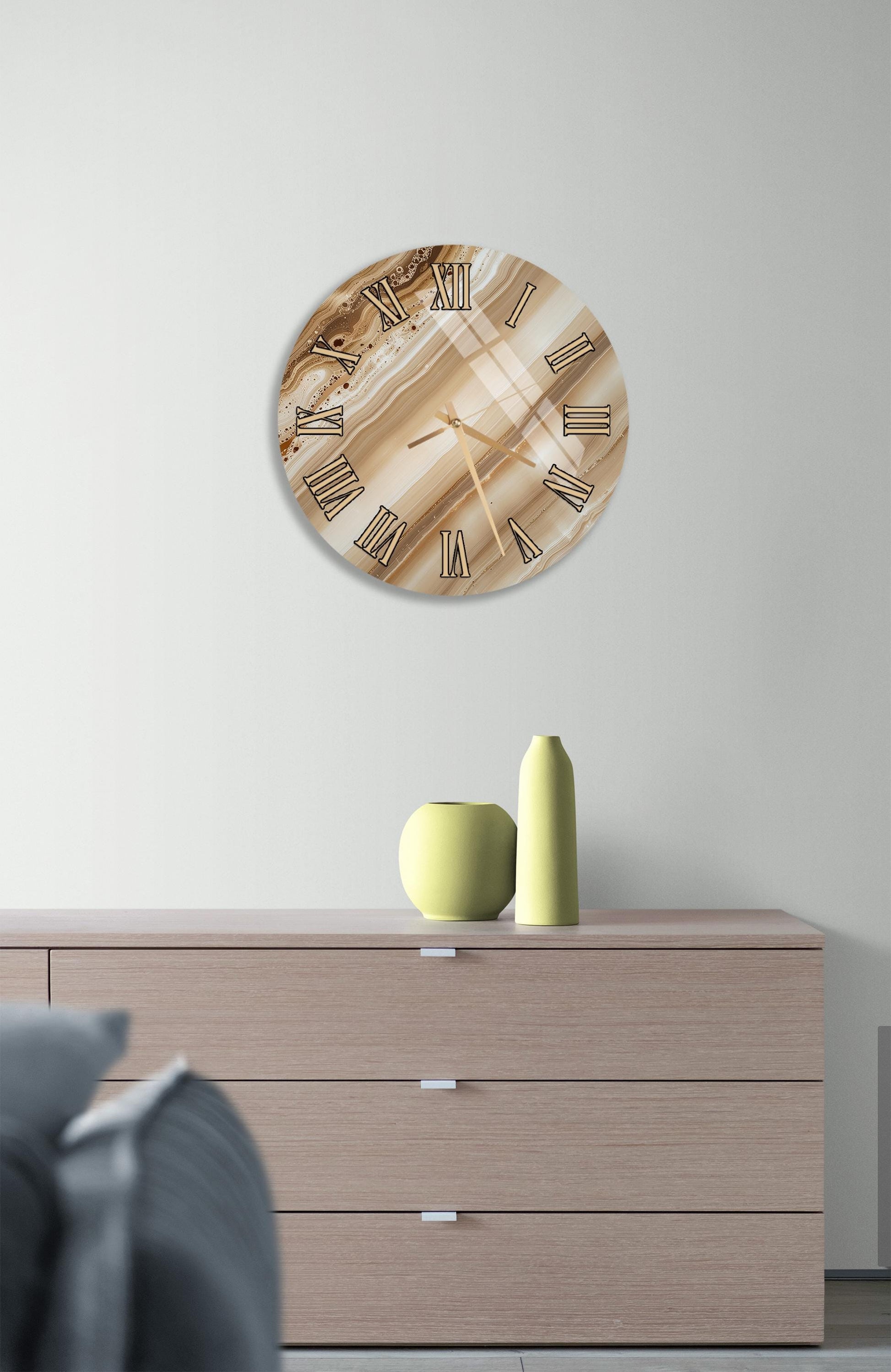 a modern living room with a wooden dresser, a round clock with a marble-like design, and a yellow vase on the dresser.