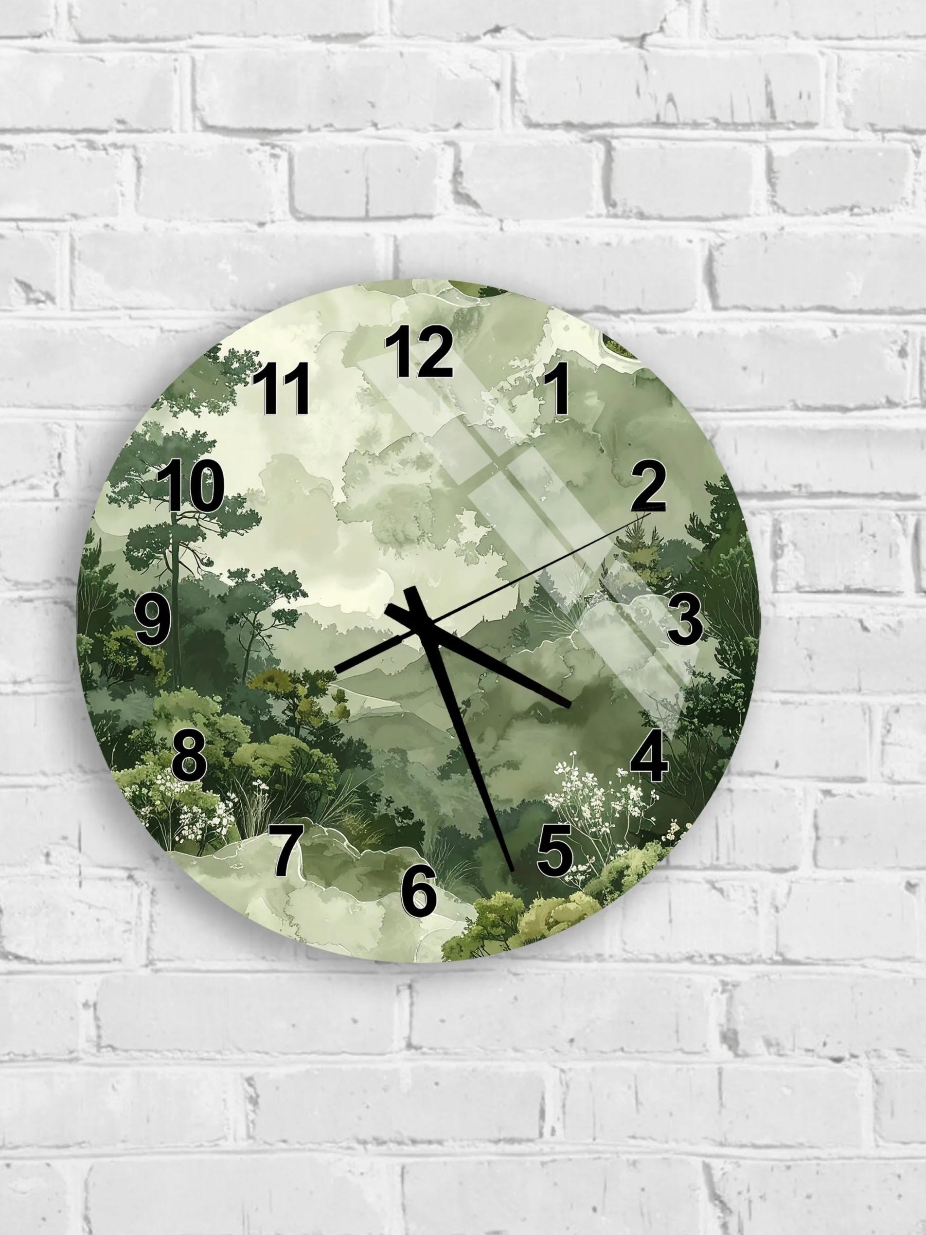 A wall clock with a green forest landscape design on its face.