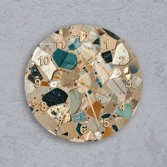 A round wall clock with a mosaic design made up of various colored tiles, including shades of green, brown, and beige.