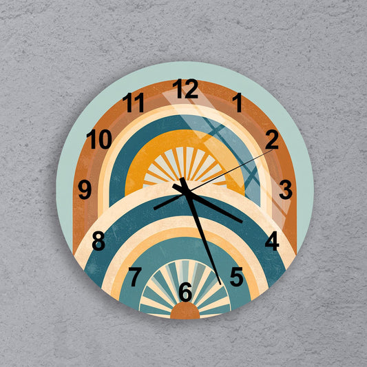 A wall clock with a colorful, abstract design featuring various shades of orange, yellow, and blue.