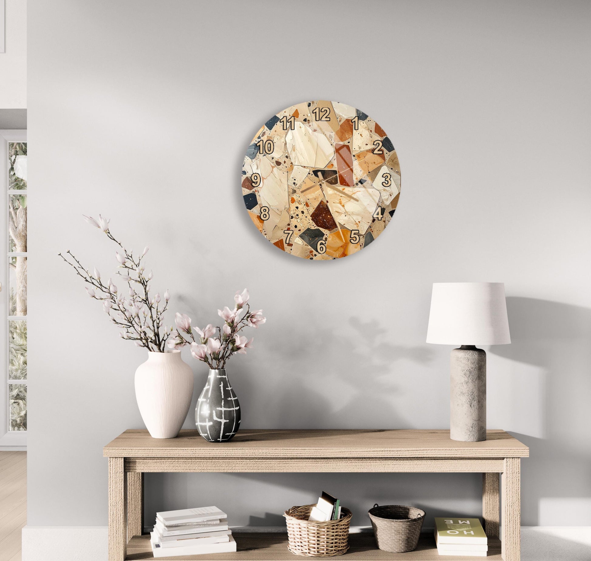 a wooden table with a vase of flowers, a lamp, and a clock on the wall above it.