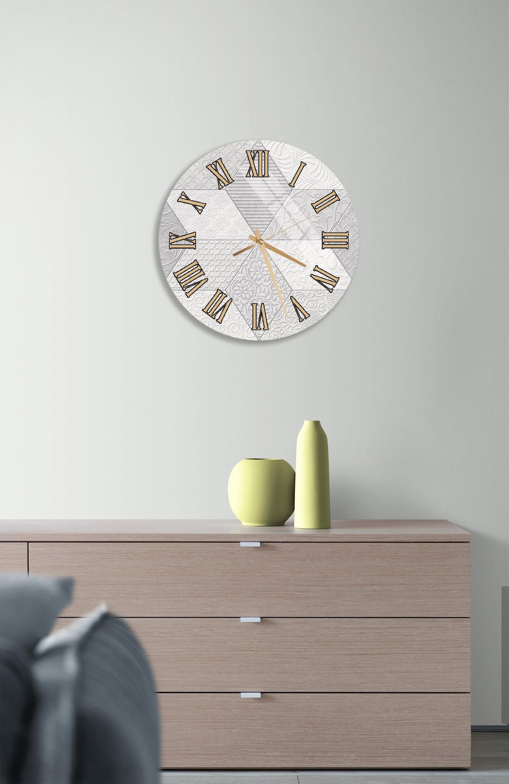a modern living room with a large wall clock displaying Roman numerals, a wooden dresser with a vase and a small green sculpture, and a gray couch in the background.