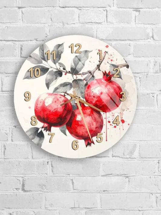 A round wall clock with a white background and a design featuring red pomegranates and leaves.