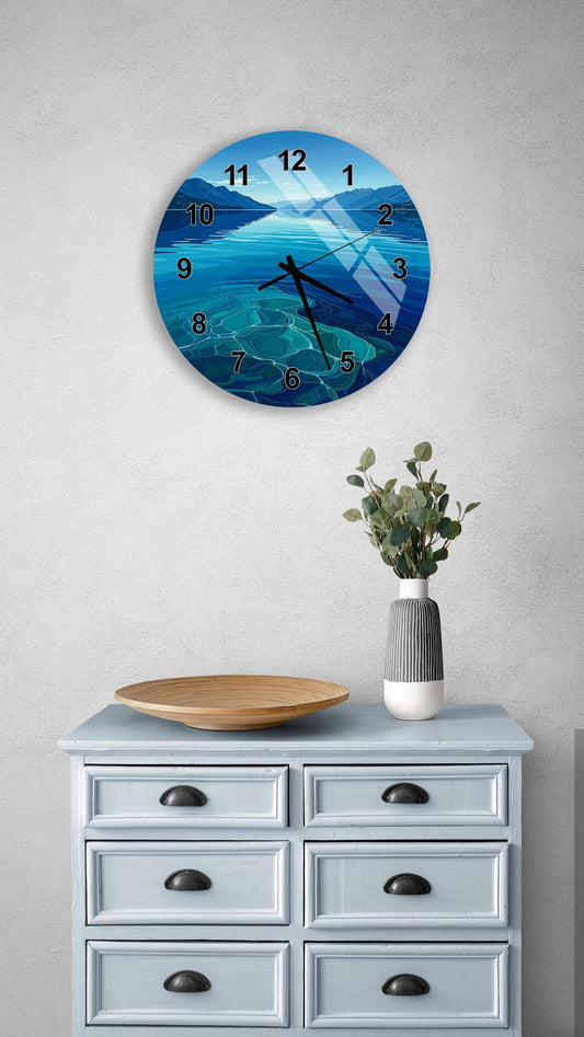 a wall clock with a blue ocean scene, a wooden bowl, and a vase of greenery on a light blue dresser.