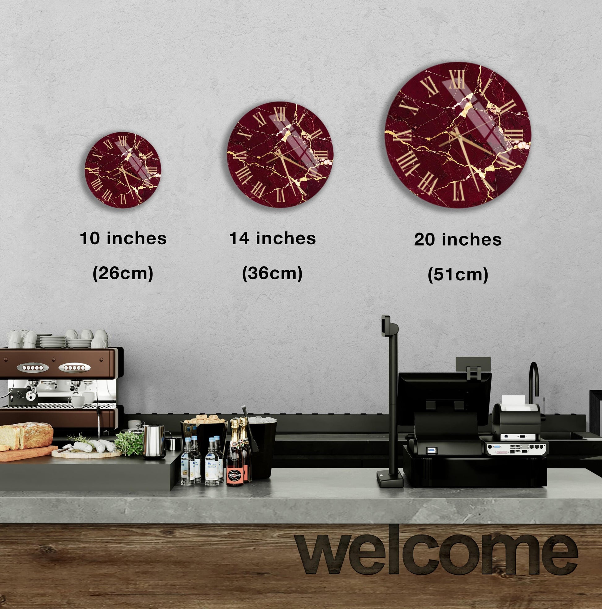 a wall with three clock faces of different sizes, each with a maroon and gold design. Below the clock faces, there is a counter with various items such as bottles and a sandwich. The word "welcome" is written on the counter.