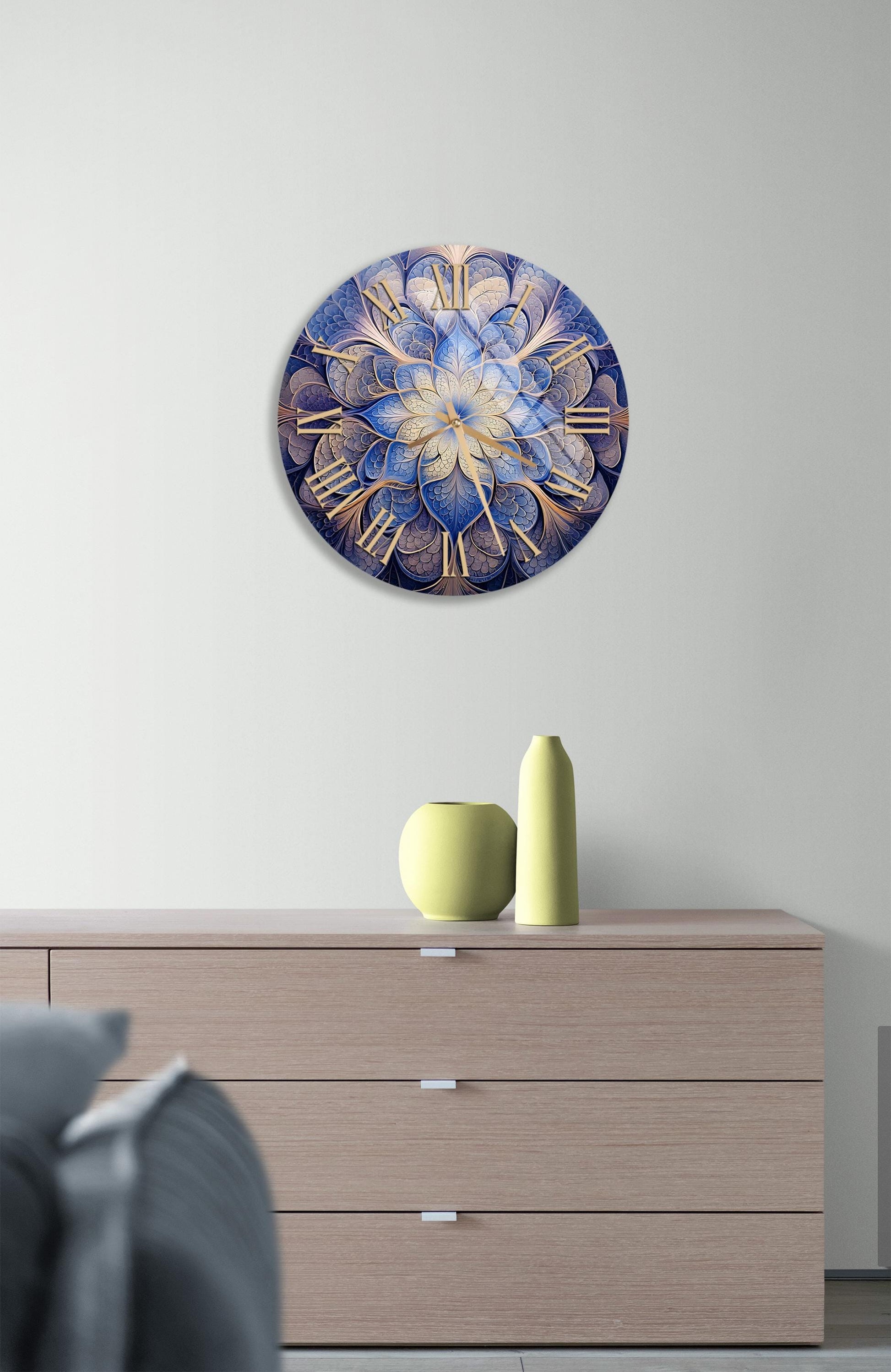 a blue and gold clock on a wall above a dresser