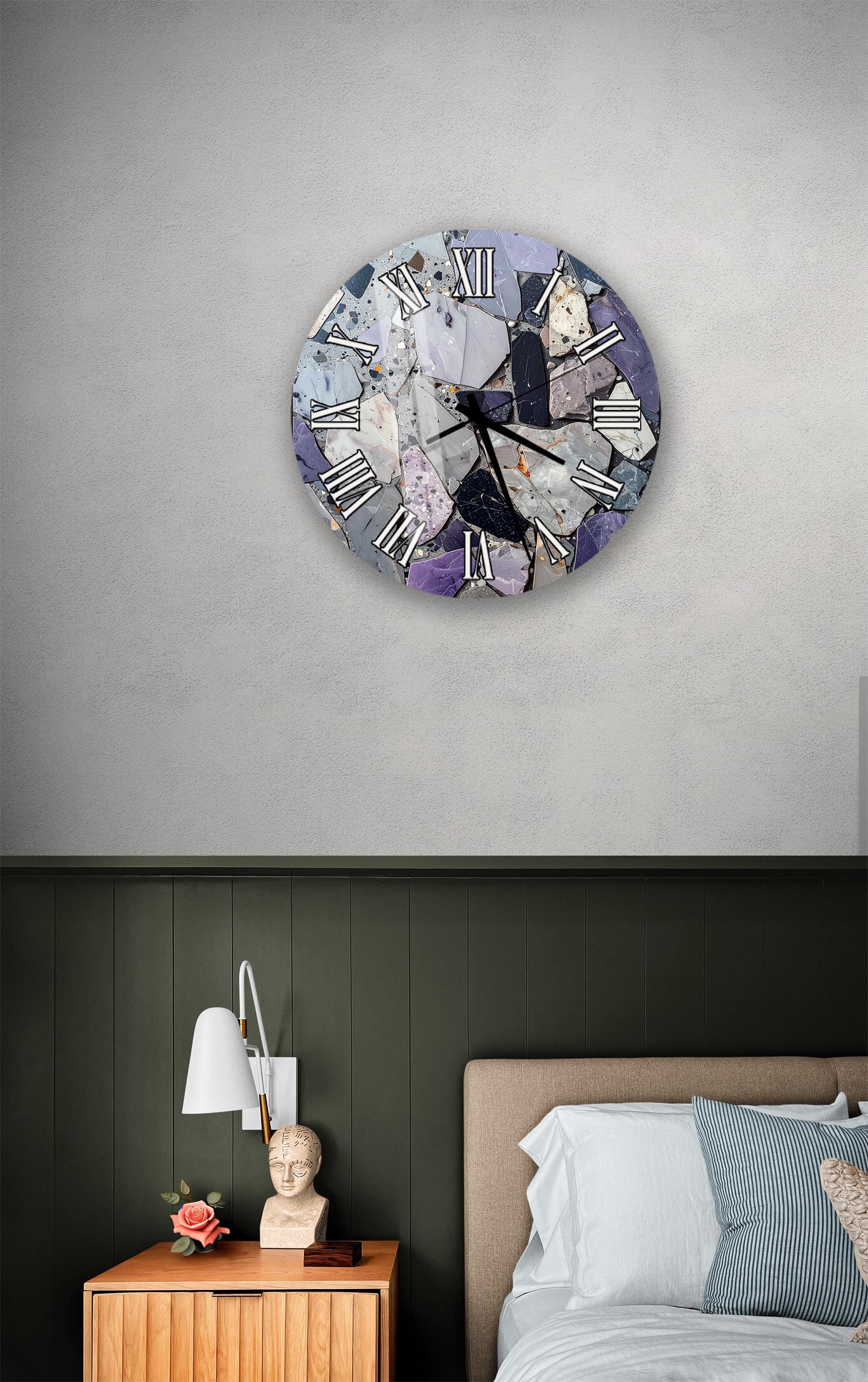 a bedroom setting with a clock on the wall, a nightstand with a lamp, and a bed with white sheets and pillows.