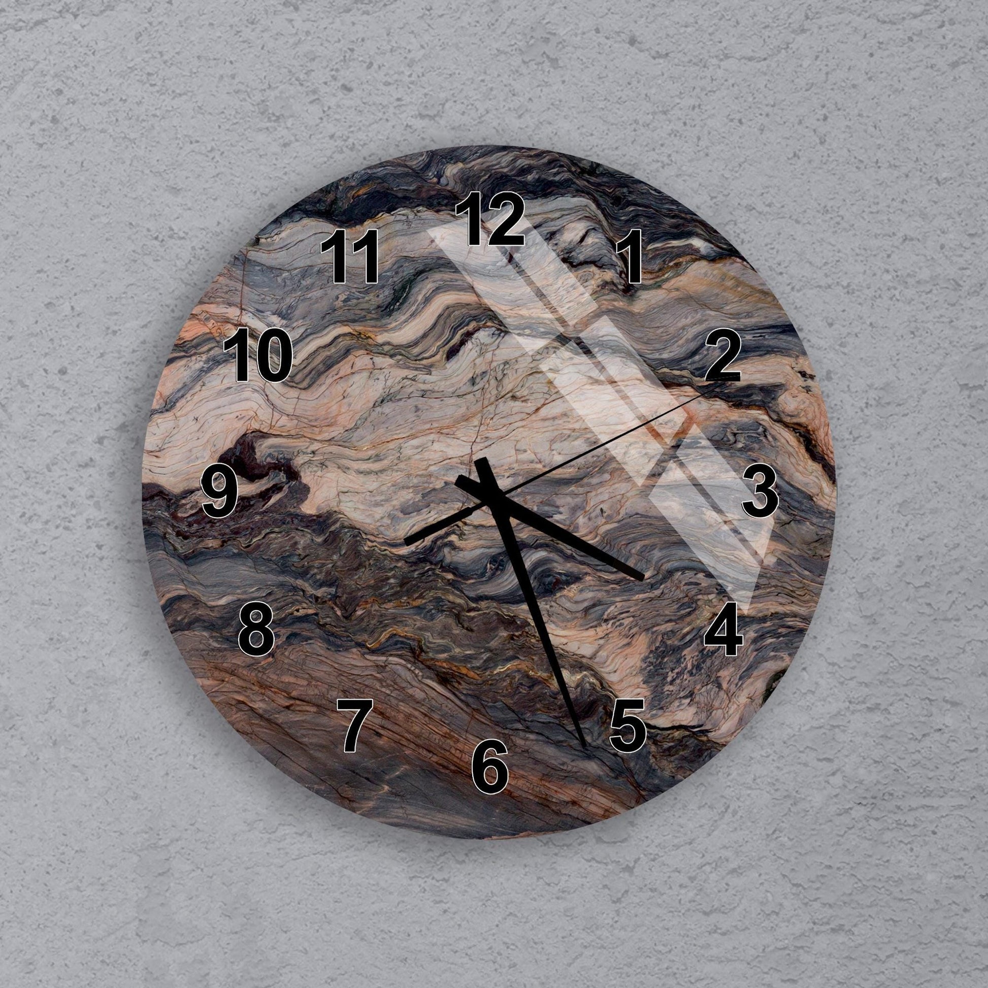 A round wall clock with a marble-like design on its face.