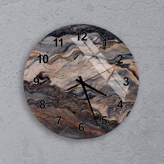 A round wall clock with a marble-like design on its face.