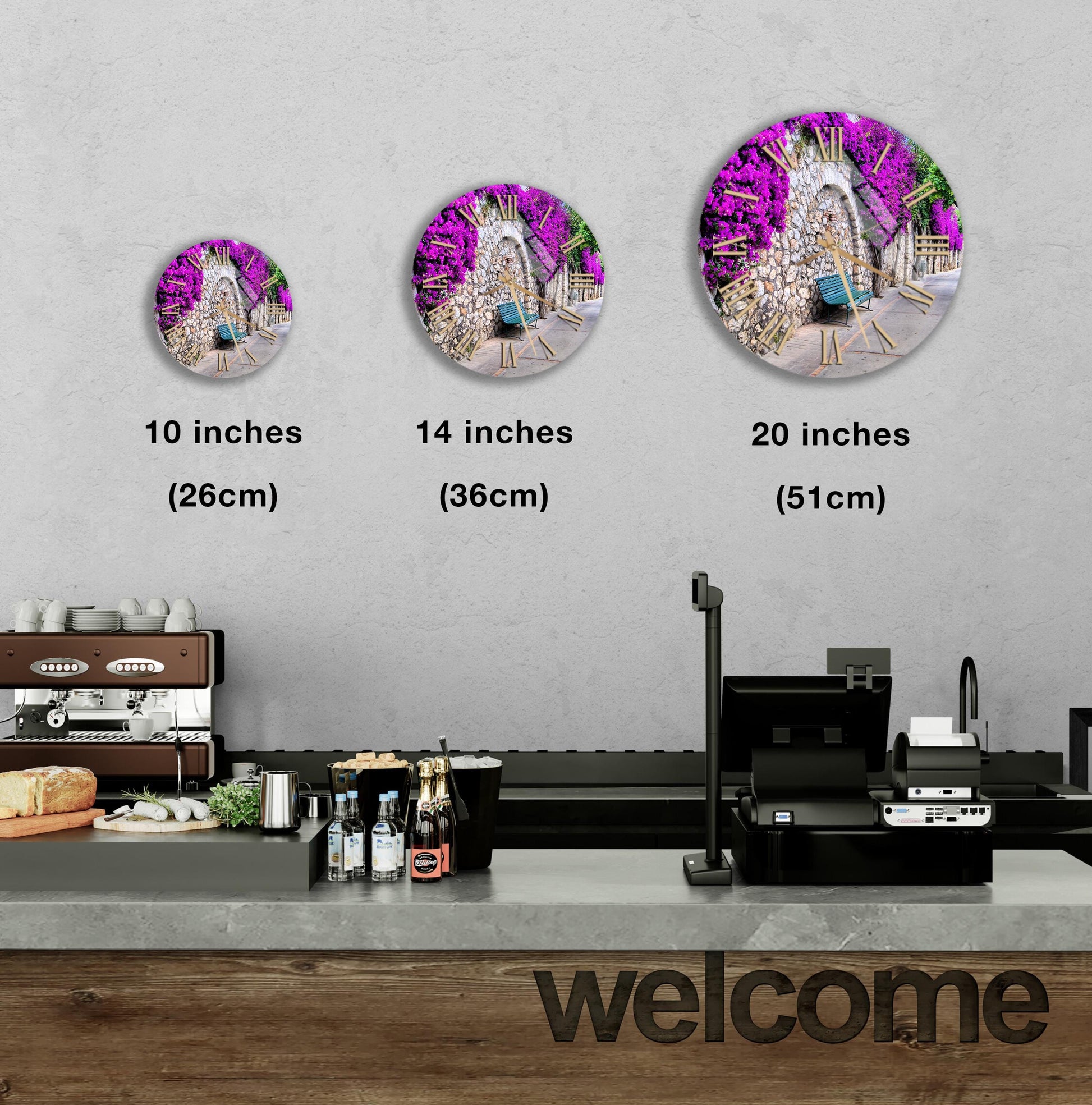 a counter with a cash register, a coffee machine, and various food and drink items displayed on it. Above the counter, there are three different-sized circular wall art pieces depicting a garden scene with purple flowers. The wall art pieces are labeled with their respective sizes: 10 inches, 14 inches, and 20 inches. The word "welcome" is also visible in the image.