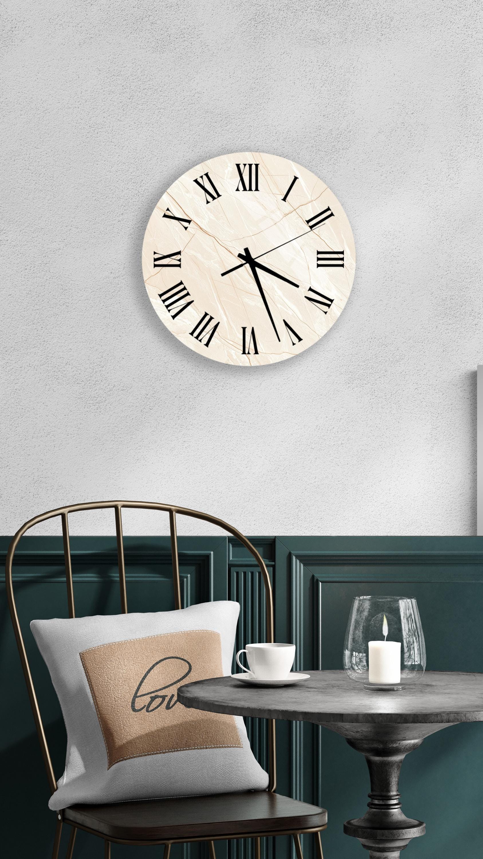 a modern interior design with a round wall clock, a black metal chair, a white table, and a beige pillow with the word "love" on it.