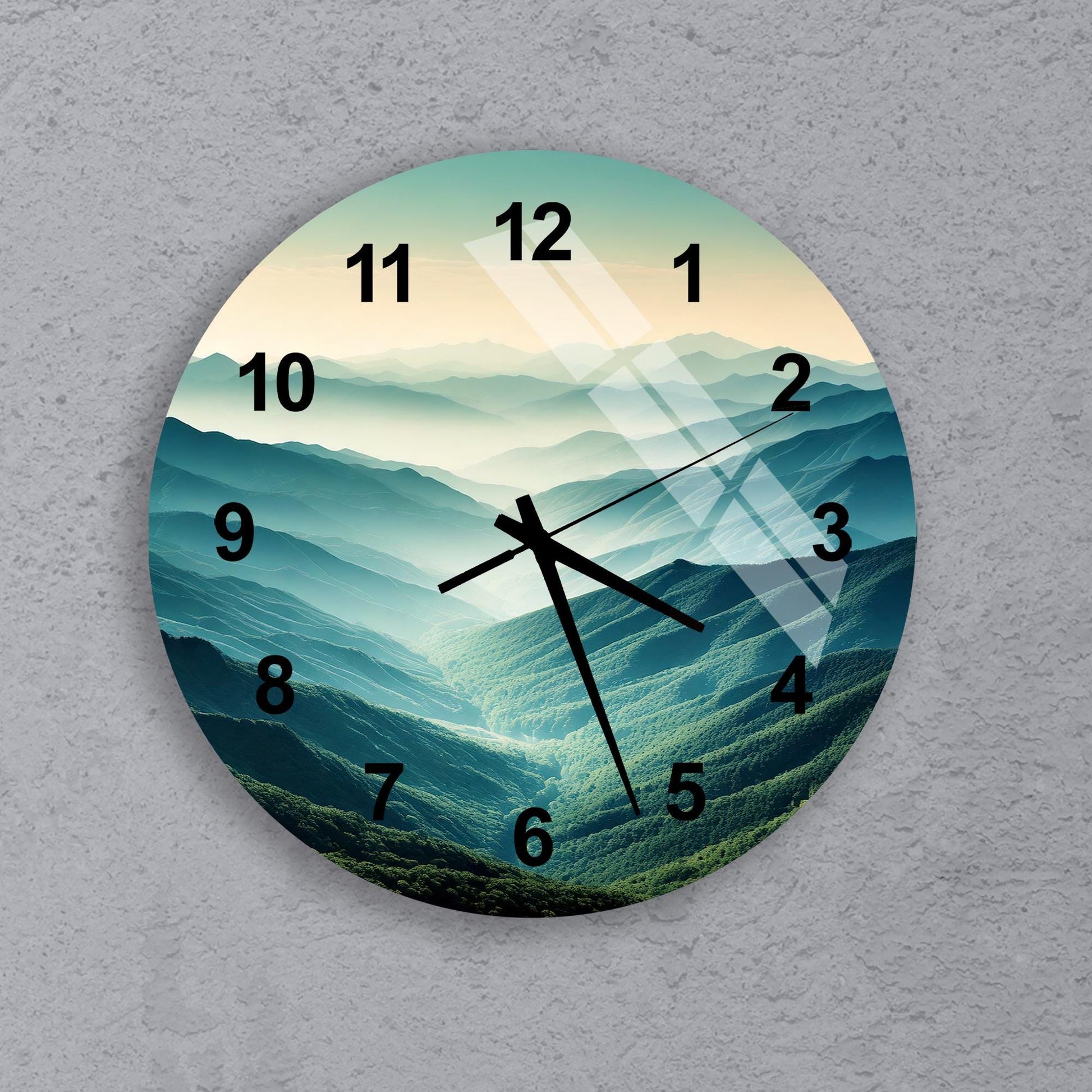 a clock with a picture of a mountain range on it