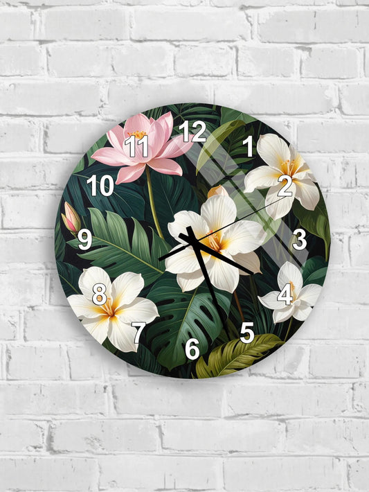 A round wall clock with a tropical flower design on the face, mounted on a white brick wall.