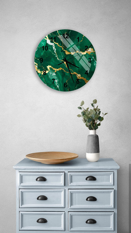 a wall clock with a green marble-like design, mounted on a wall above a light blue dresser with six drawers. The dresser also has a vase with greenery and a wooden bowl on it.