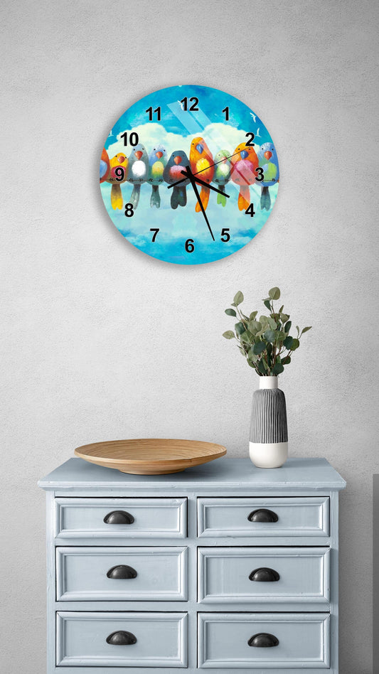 a clock with a bird design on it, mounted on a wall above a wooden dresser with drawers.