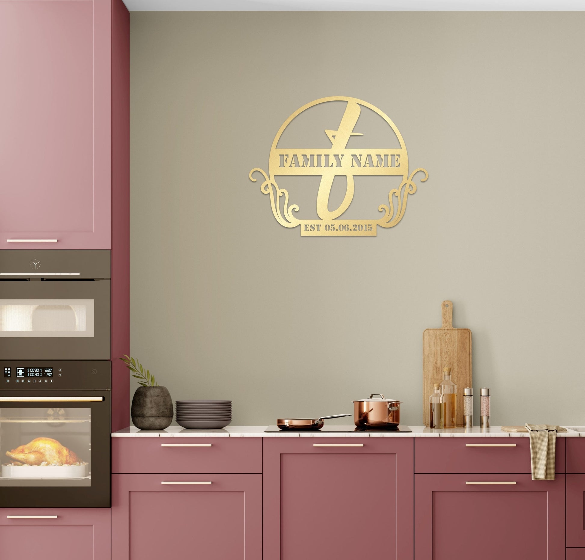 a kitchen with pink cabinets and a gold family name sign