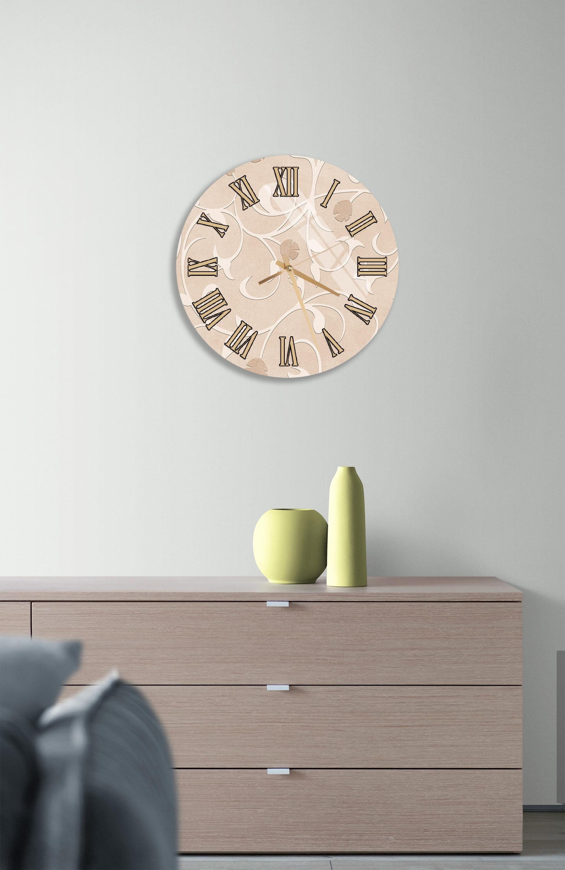 a wall clock with Roman numerals, a wooden dresser, and a small green vase on top of the dresser.