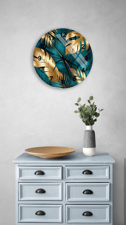 a wall clock with a tropical leaf design, a wooden bowl, and a vase with greenery, all placed on a light blue dresser with six drawers.