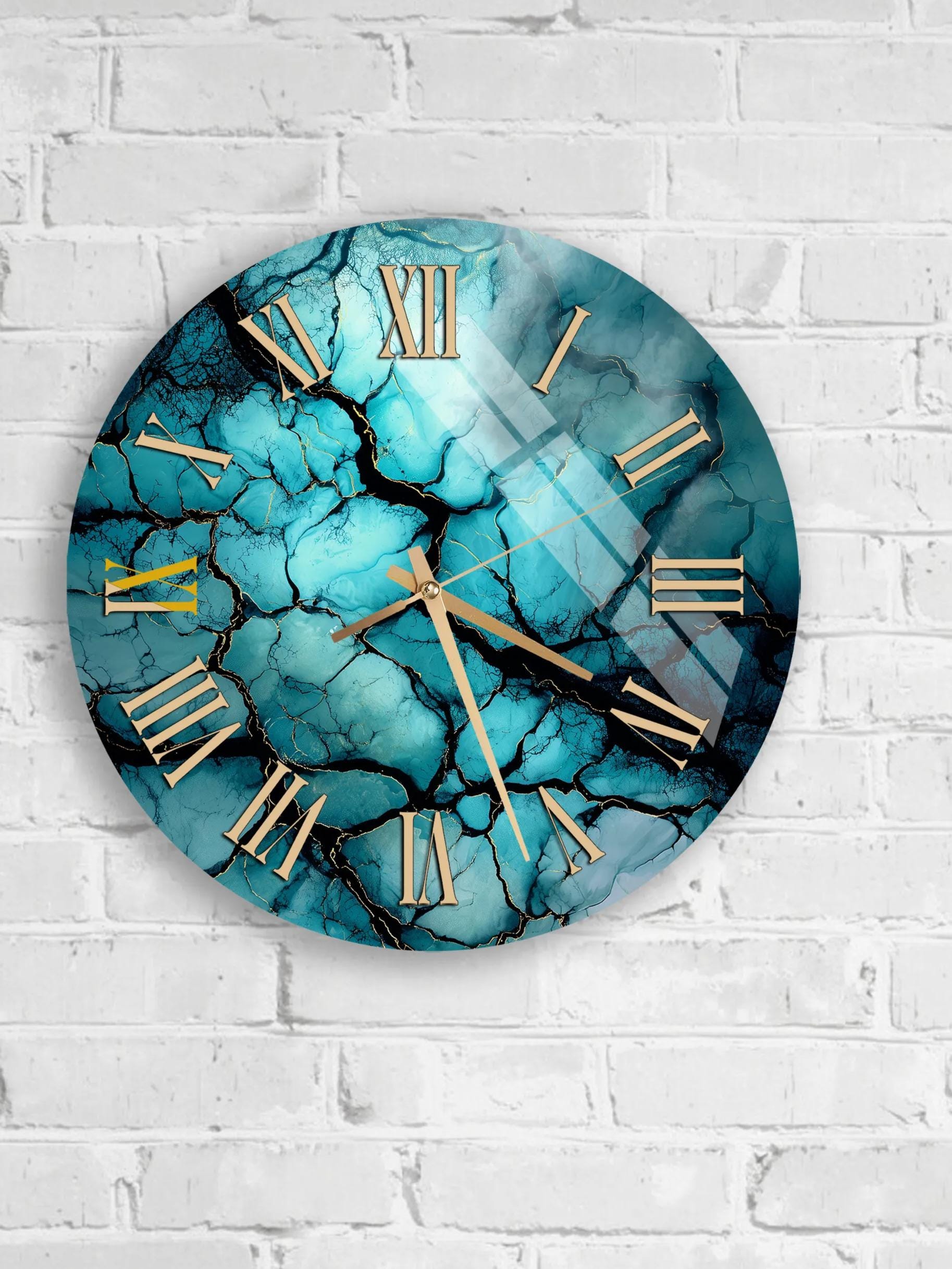 A round wall clock with a marble-like blue and black design, mounted on a white brick wall.