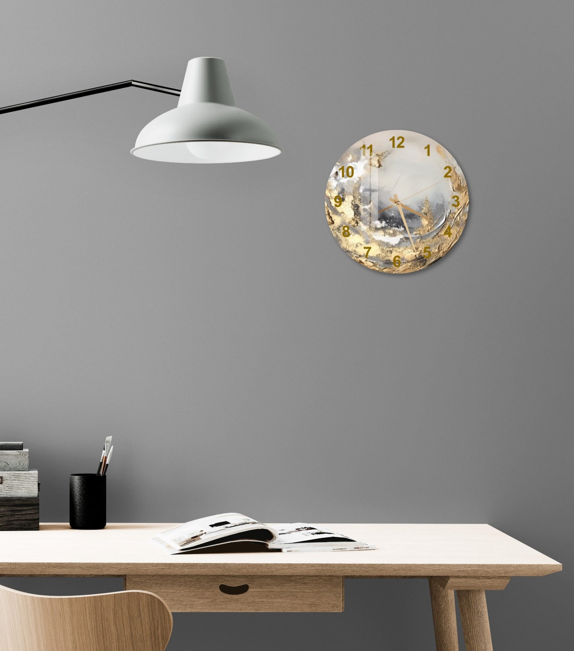 a desk with a lamp and a clock on the wall
