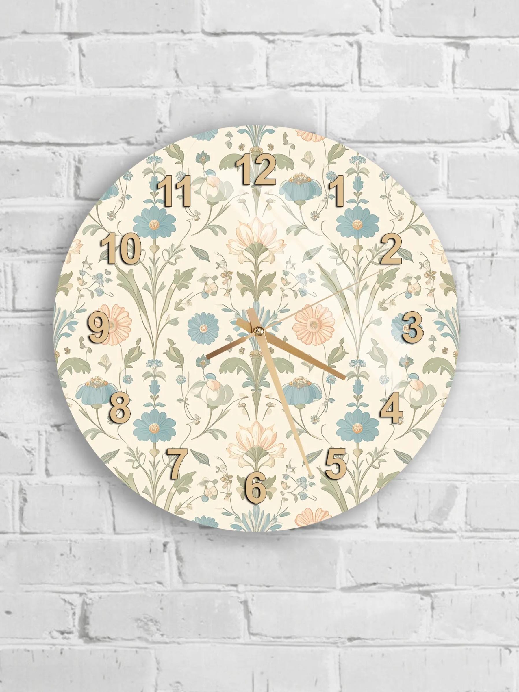 A round wall clock with a floral pattern and numbers on a white brick wall.