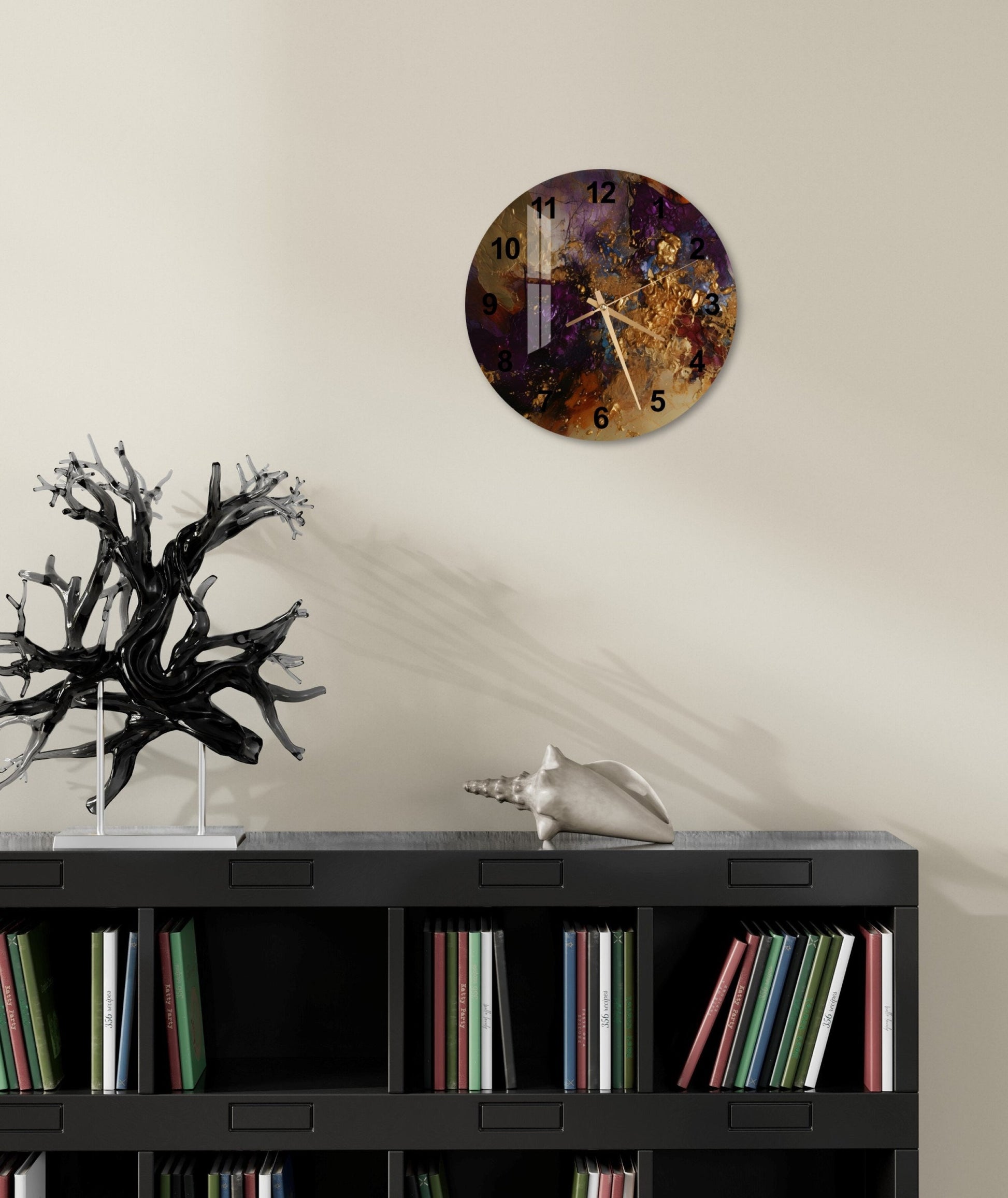 a clock on a wall above a bookcase