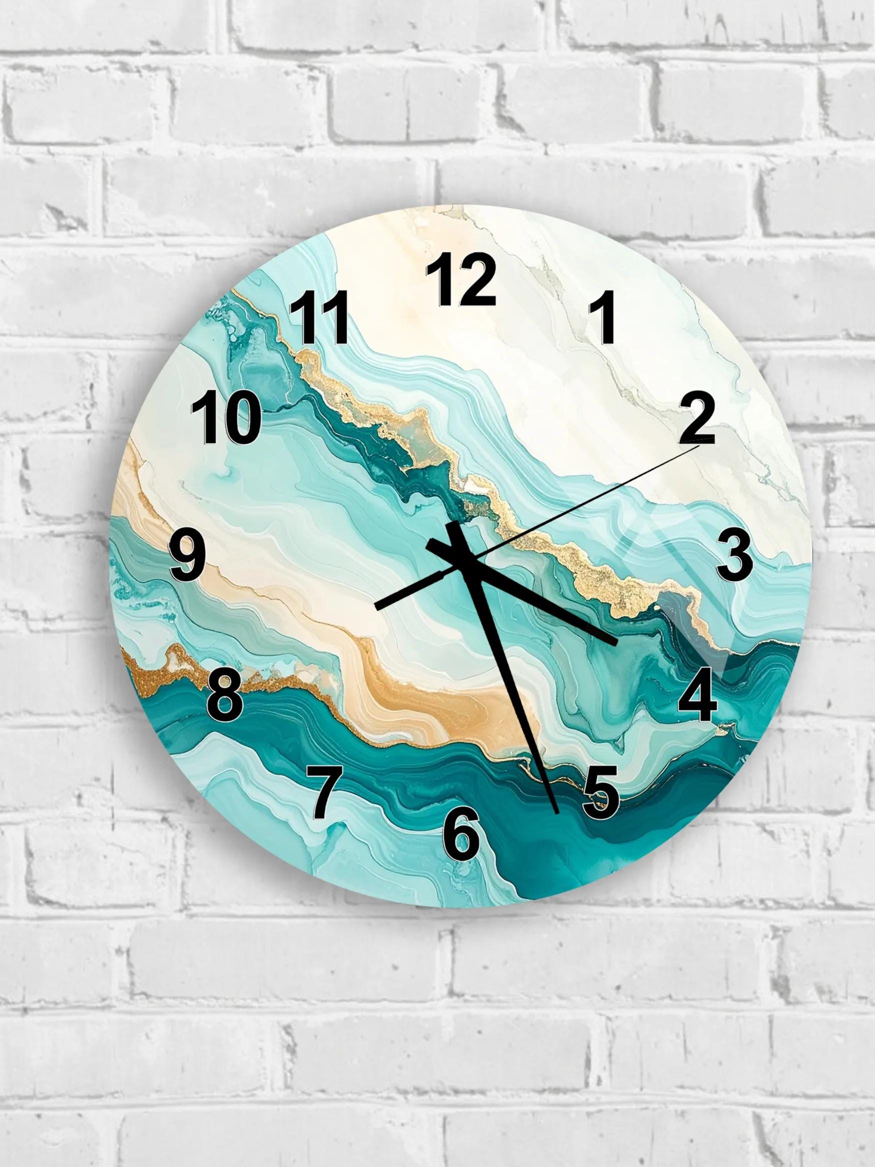 A round wall clock with a marble-like design in shades of blue and white, mounted on a white brick wall.