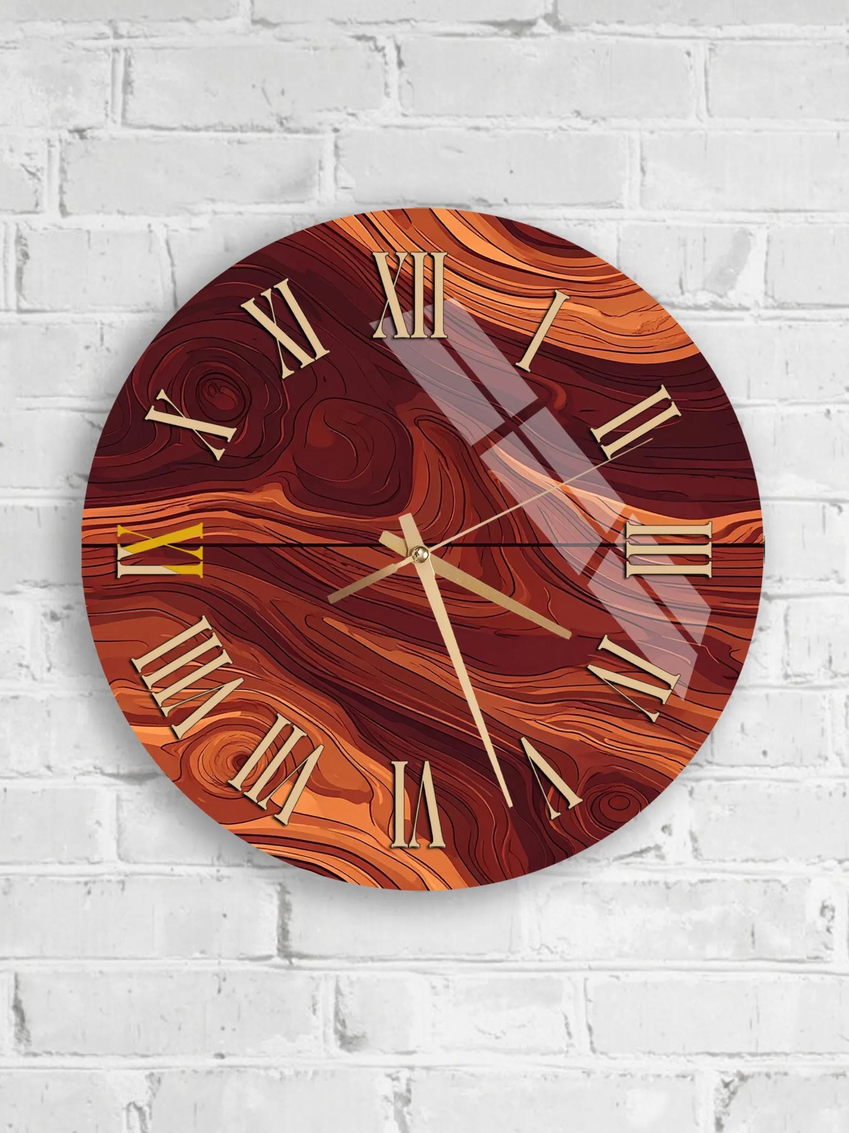A round wall clock with a marbled design and gold Roman numerals is mounted on a white brick wall.