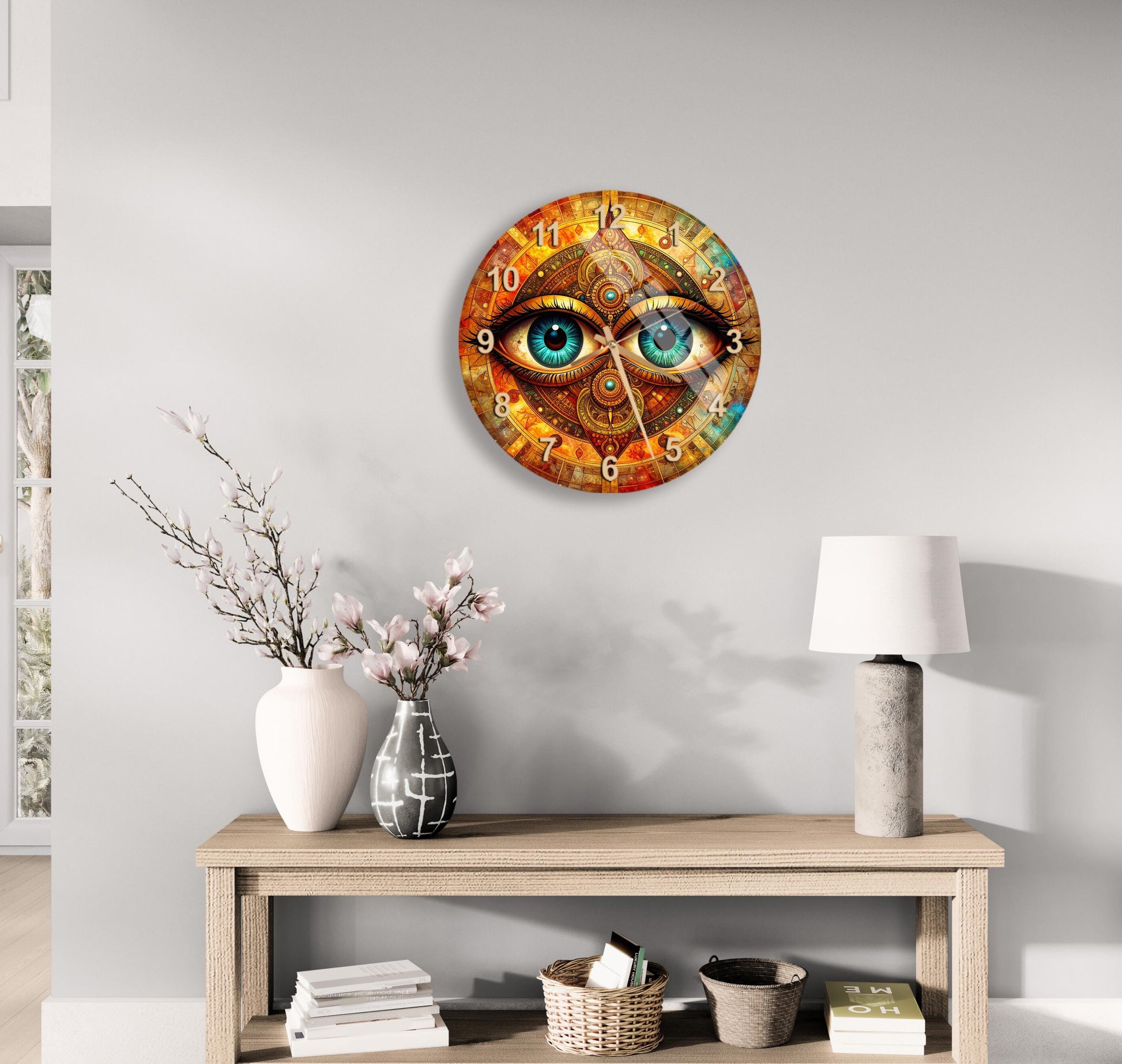 a wall clock with a unique design, hanging on a wall above a wooden table with various decorative items, such as a vase with flowers and a lamp.