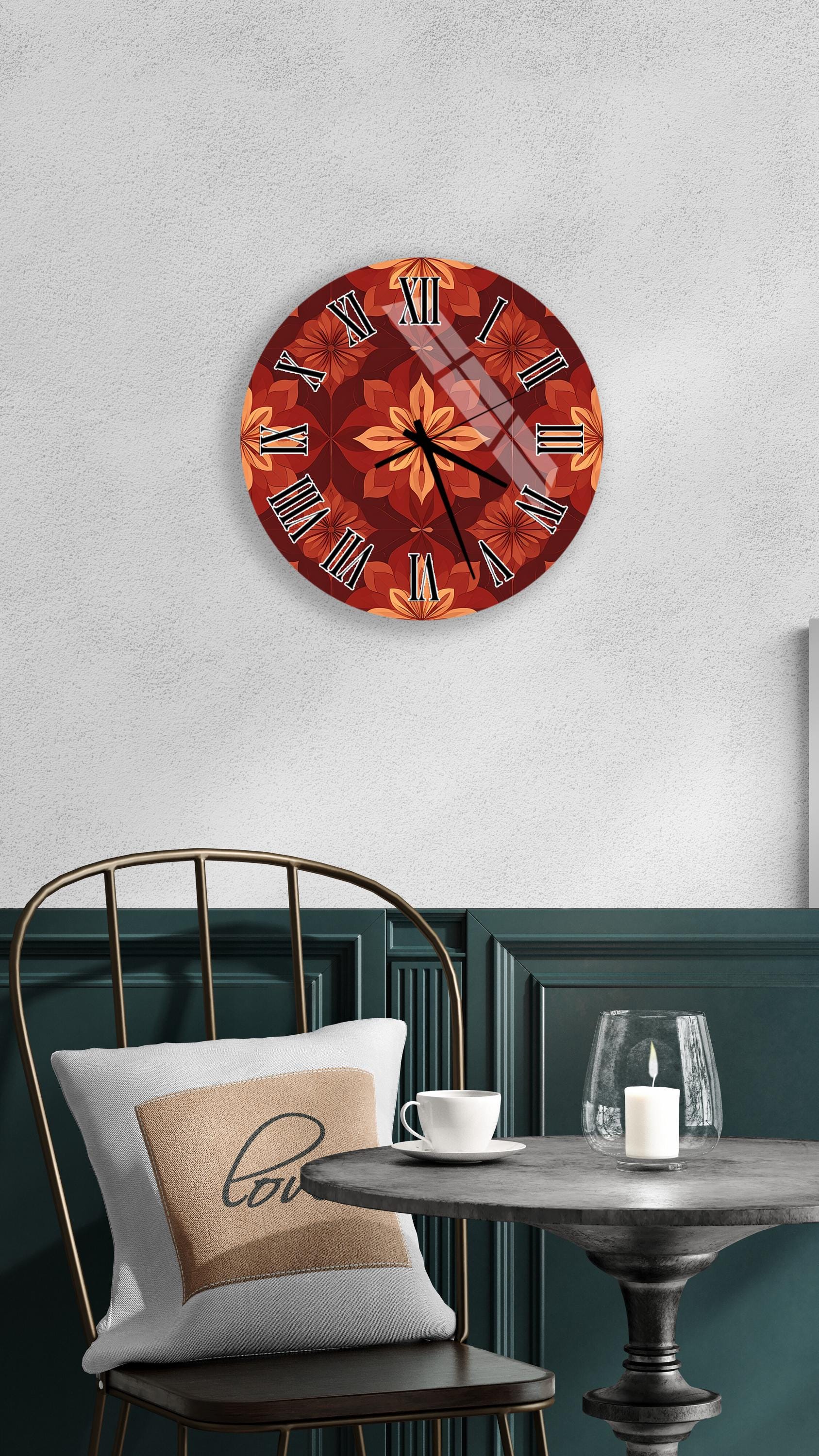 a wall clock with a floral design, a white table with a candle and a cup, and a green chair with a pillow.