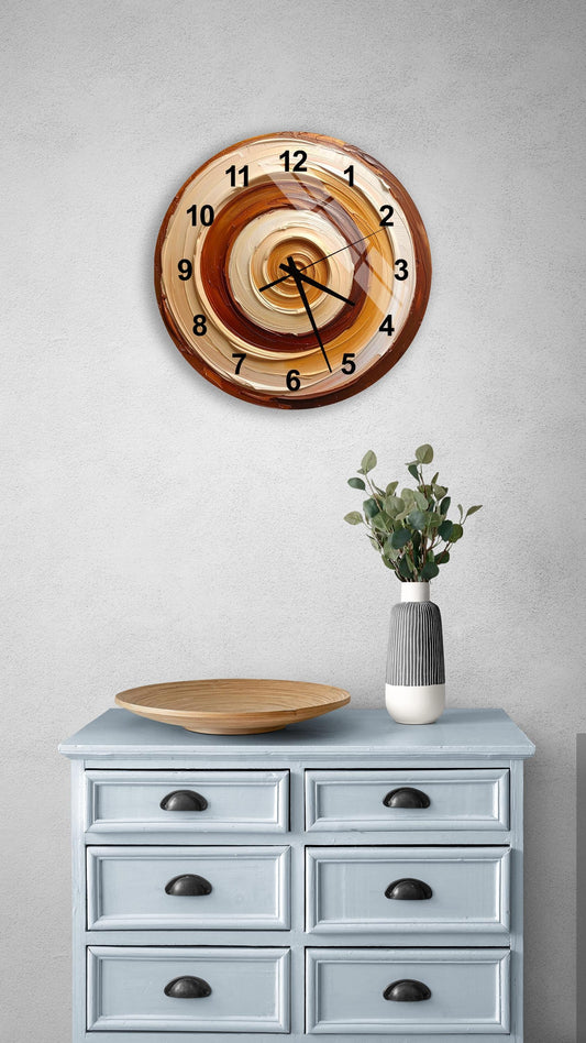 a wall clock with a brown and orange spiral design, mounted on a light blue dresser with six drawers. The dresser also has a wooden plate and a vase with greenery on it.