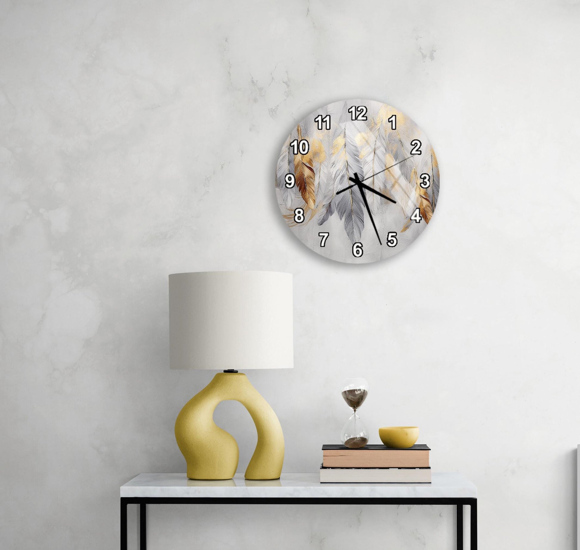 a modern living room with a white marble wall, a round wall clock with a feather design, a yellow lamp with a unique curved base, and a small table with a book and a glass of wine.