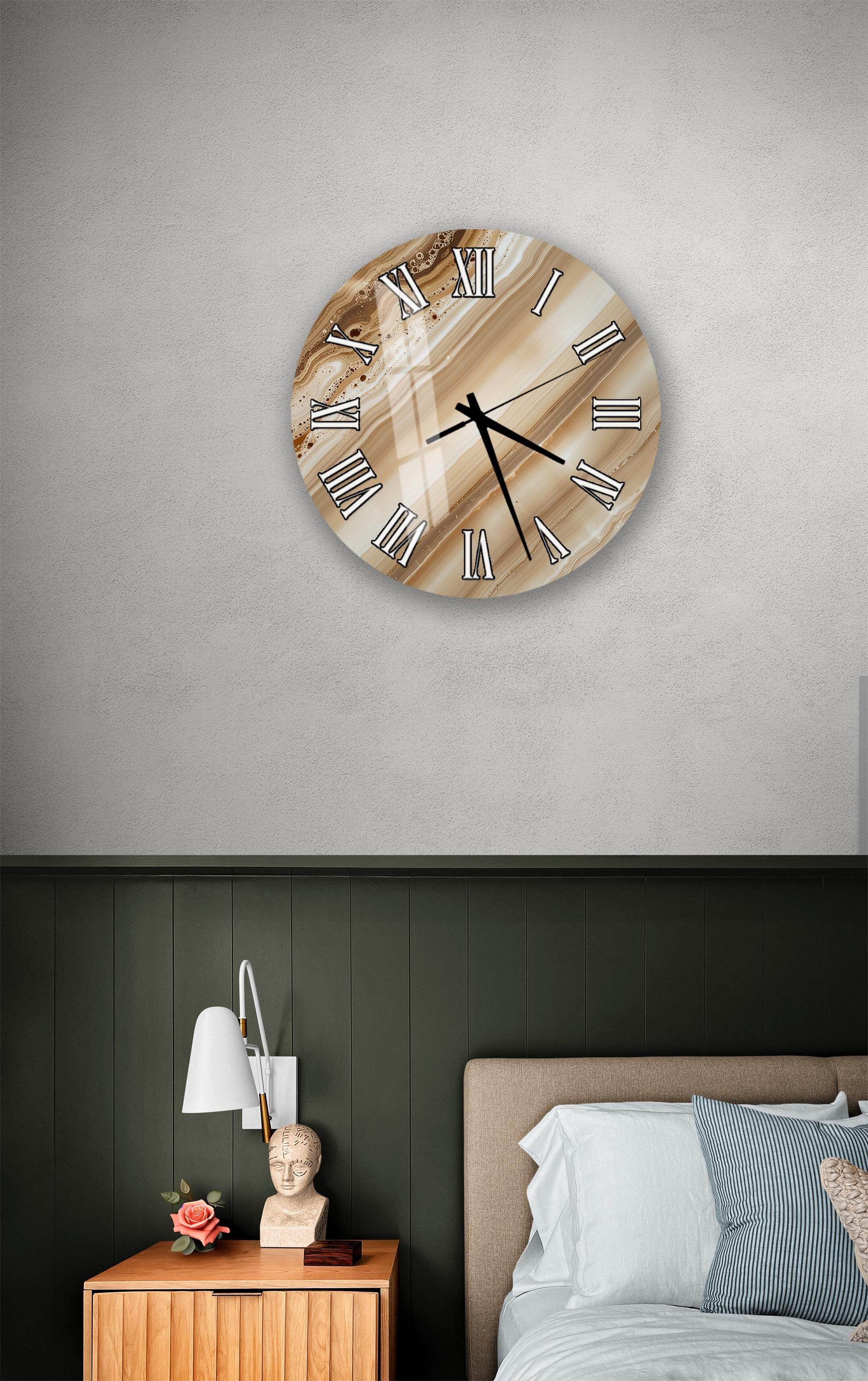a bedroom setting with a round wall clock, a wooden nightstand, and a bed with white pillows.