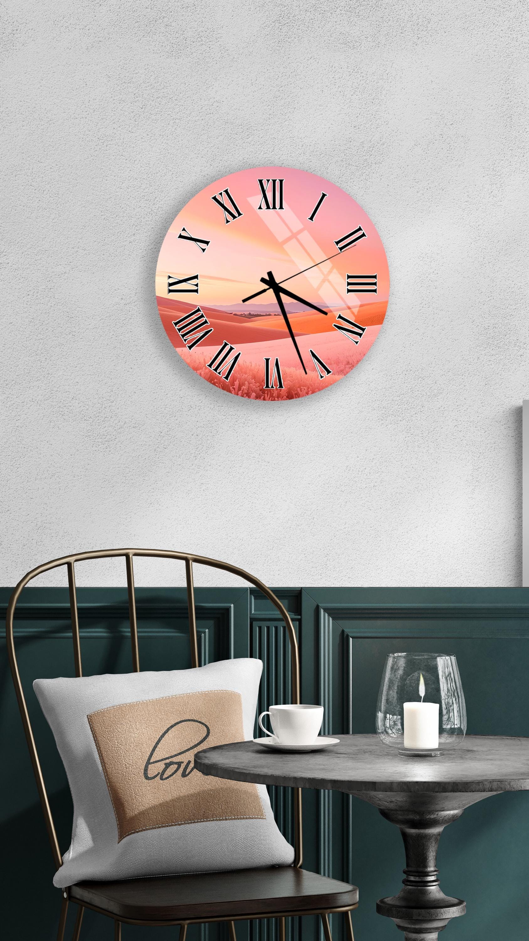 a wall clock with a sunset-like design, mounted on a wall above a table with a white tablecloth and a candle.