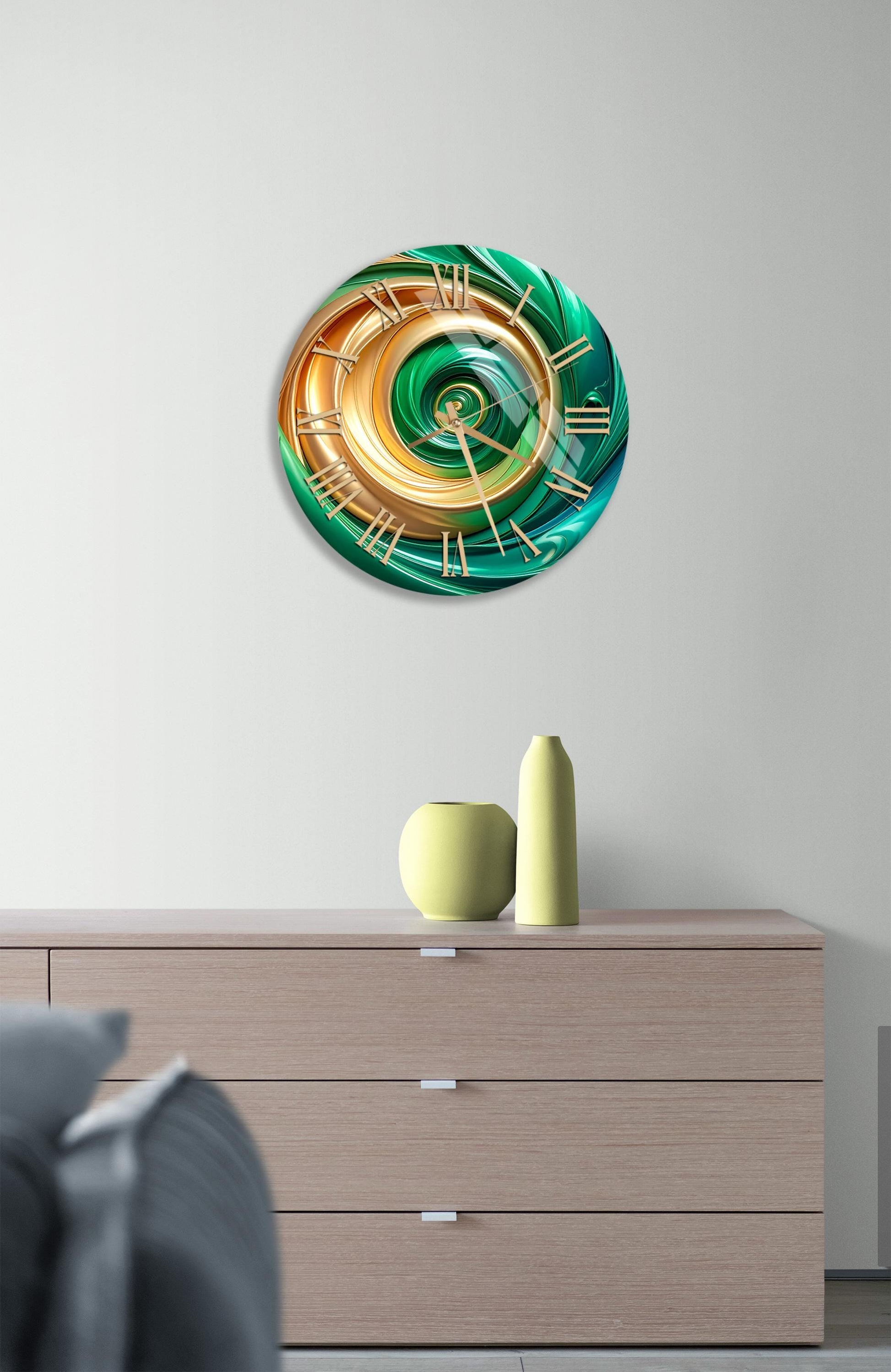 a modern clock with a unique design, hanging on a wall above a wooden dresser.