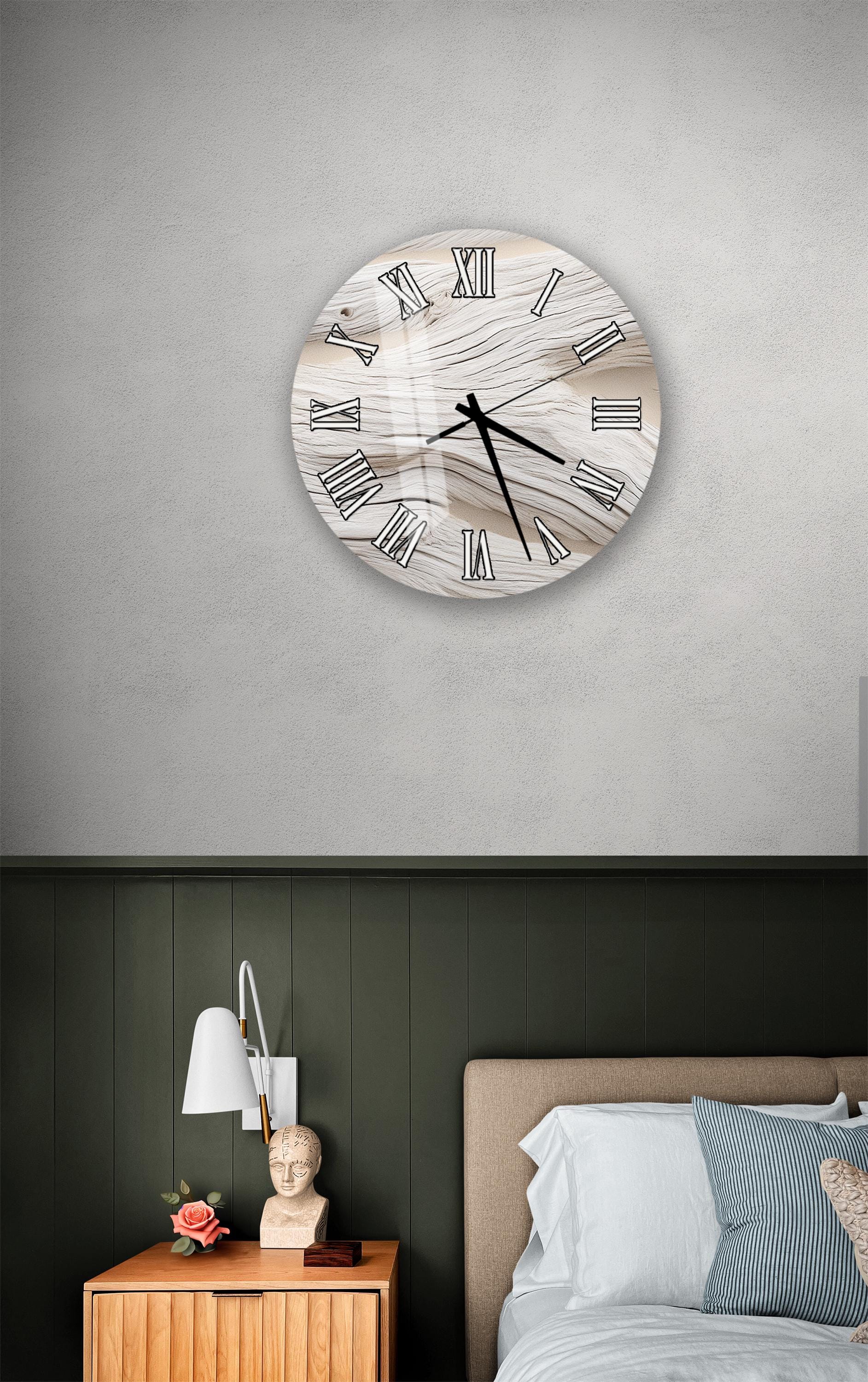a bedroom setting with a wall clock, a nightstand, and a bed.