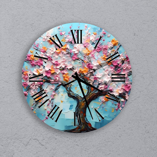 A round wall clock with a blue background and a tree with pink and orange flowers.
