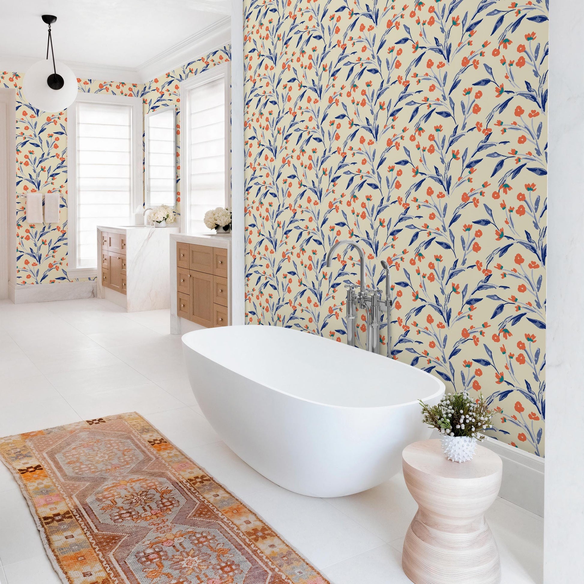 a modern bathroom with a large freestanding bathtub, a colorful rug, and a patterned wallpaper.