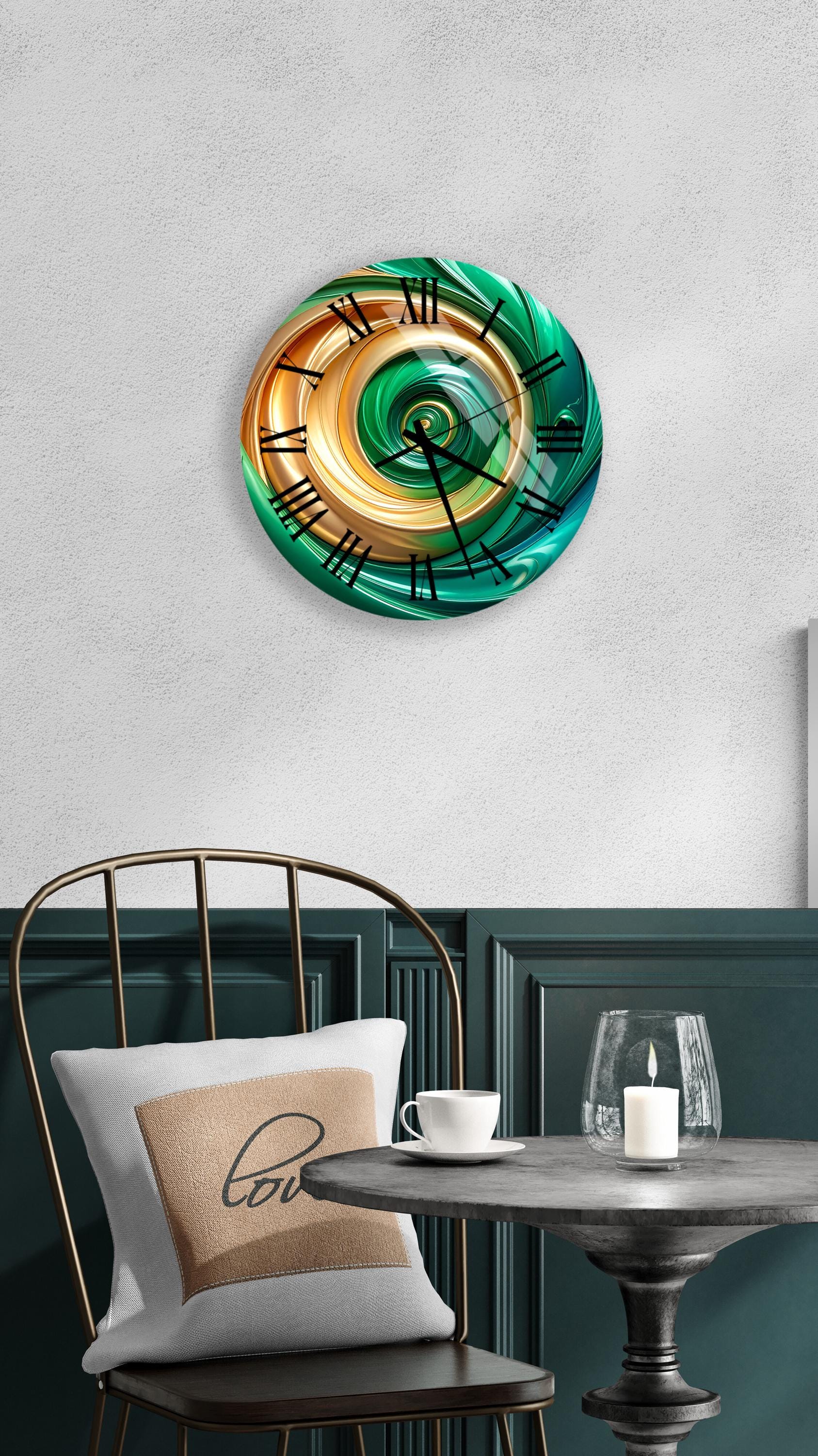 a modern, abstract clock with a spiral design in shades of green and orange, mounted on a wall above a table with a white tablecloth.
