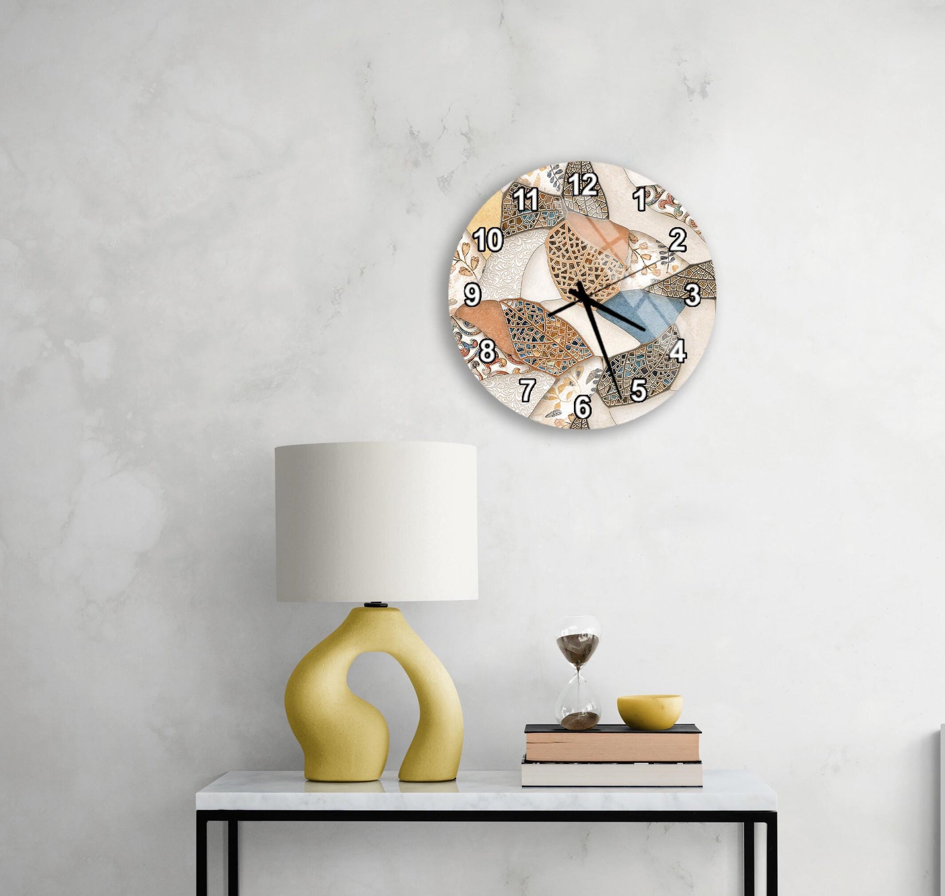 a modern living room with a white marble wall, a round clock with a unique design, a yellow lamp with a curved base, a stack of books, and a glass of wine on a white table.