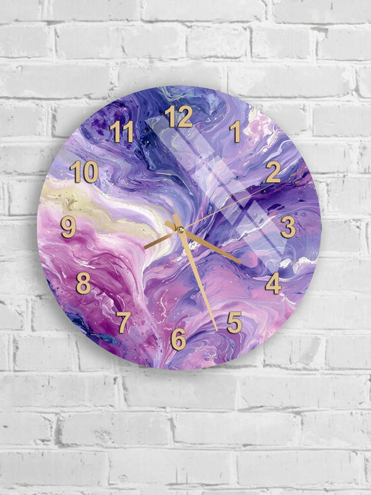 A wall clock with a vibrant purple and pink marble design, mounted on a white brick wall.