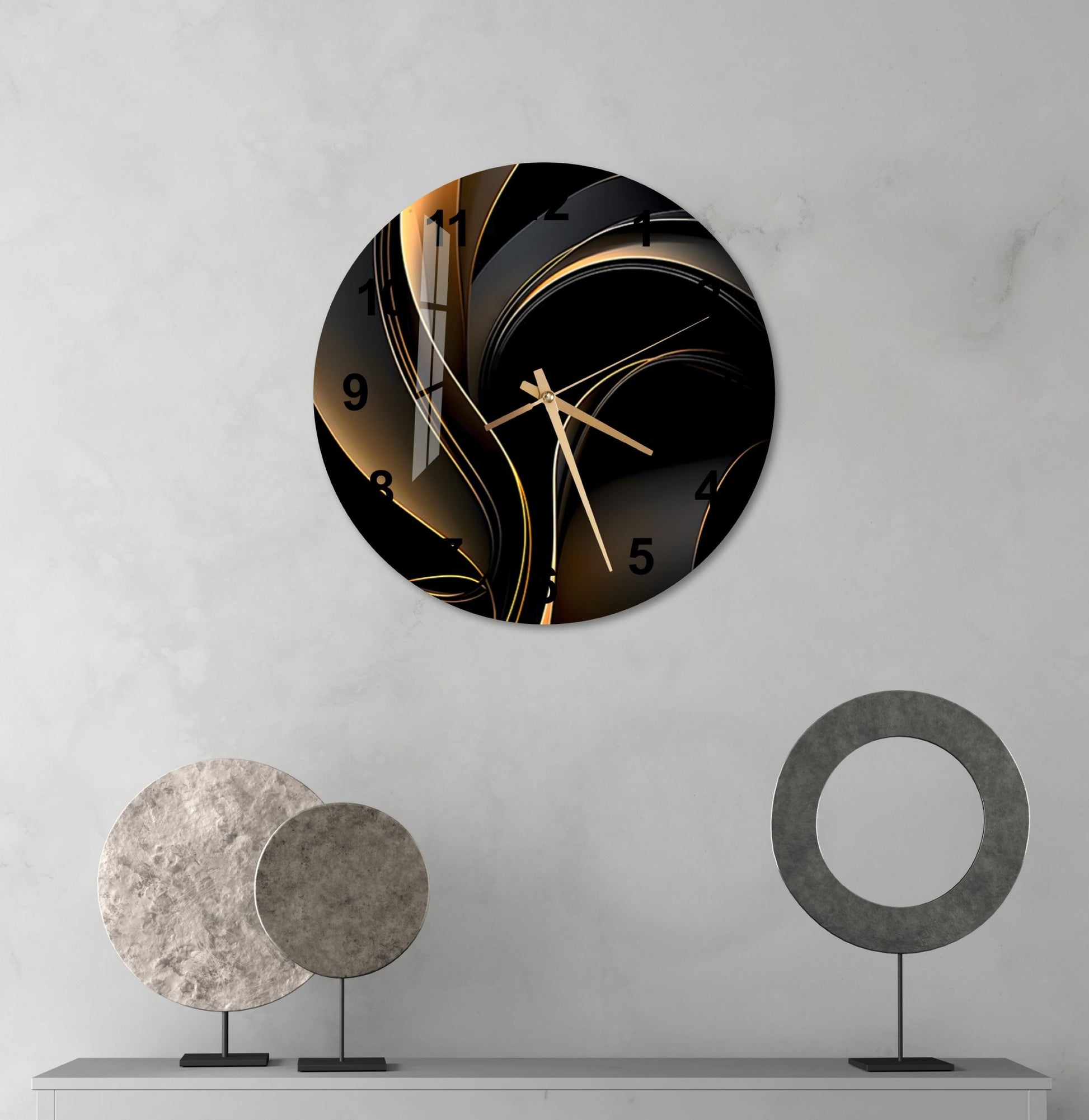 a black and gold clock on a white wall